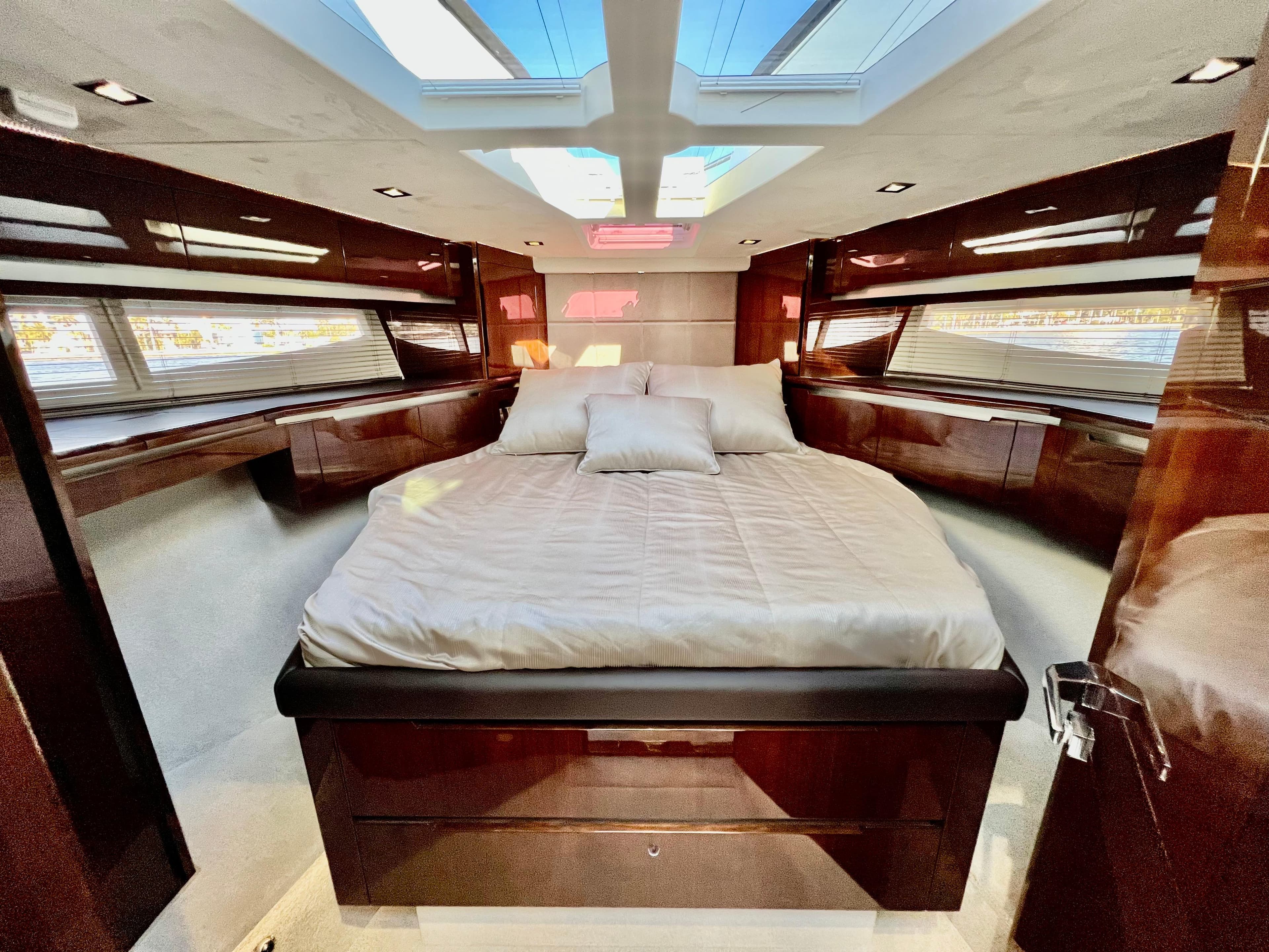 Luxurious master cabin of 2022 Galeon 470 Sky yacht with skylights and modern design.