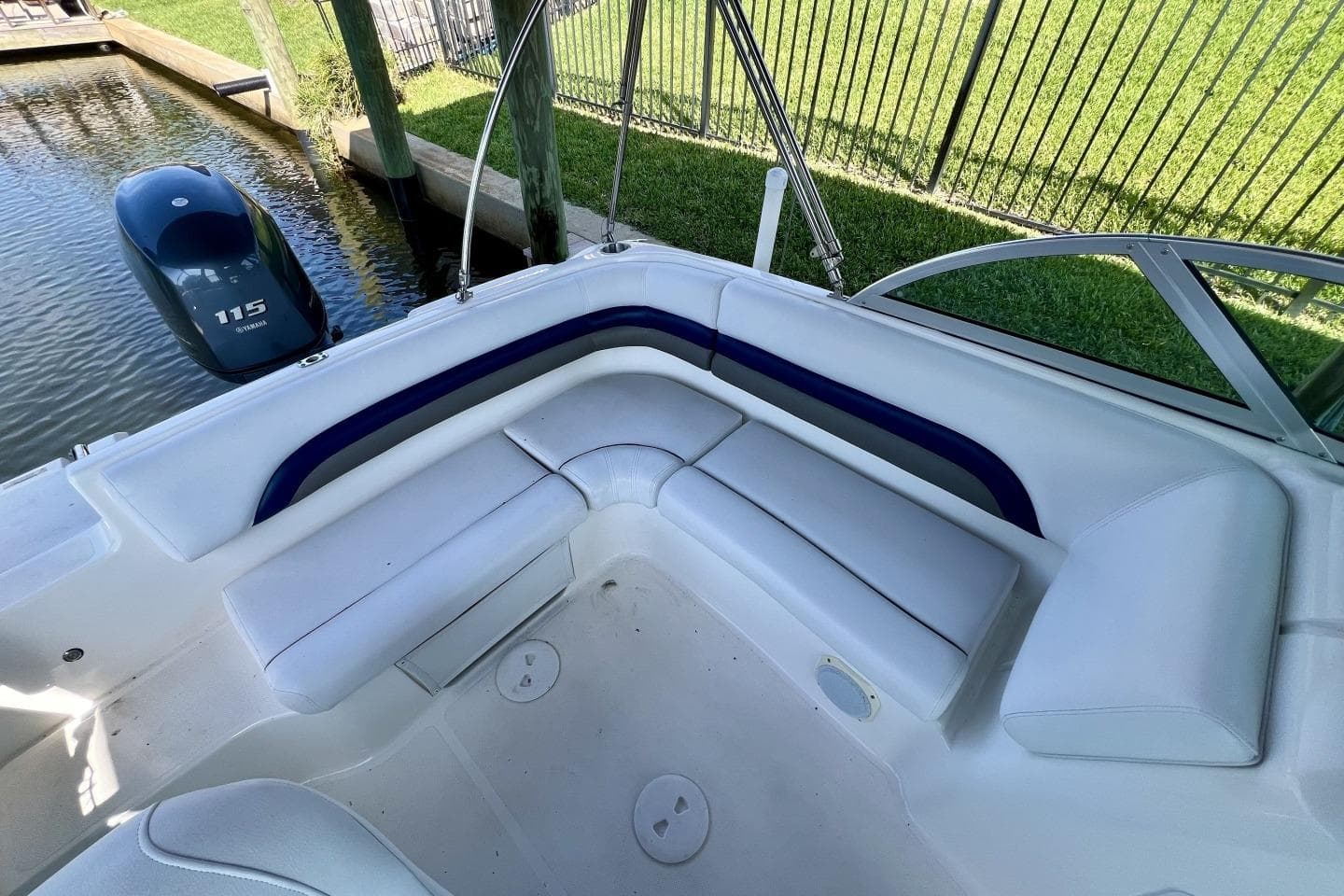 2013 Hurricane SunDeck 187 OB boat interior with white seating and Yamaha 115 outboard motor.