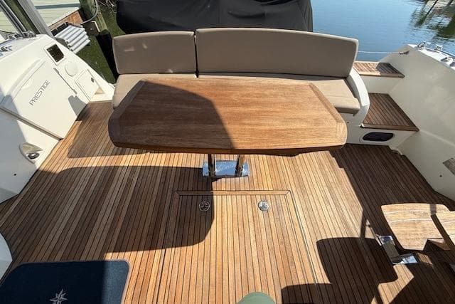 Prestige 500 yacht deck with wooden table and seating, 2015 model.