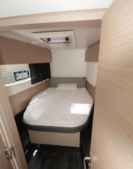 2021 Fountaine Pajot Catamaran Astrea 42 cabin with bed, modern interior design.