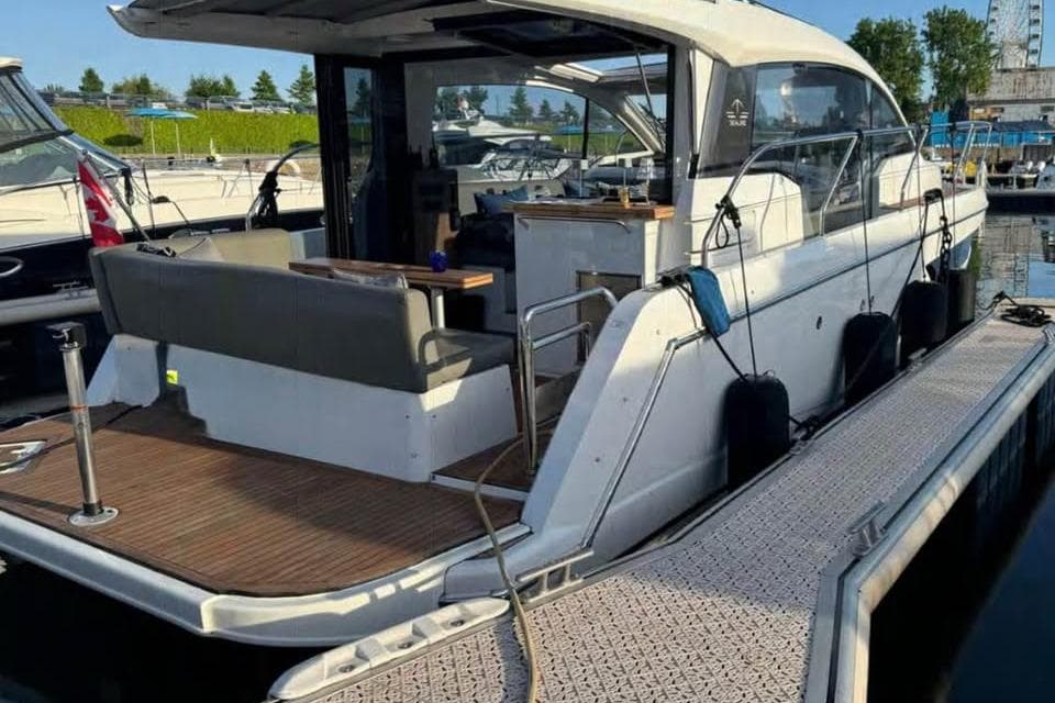 2018 Sealine C330 yacht docked at marina, featuring spacious deck and modern design.