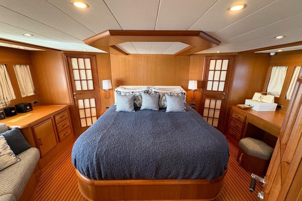 Luxurious cabin interior of 2006 Mochi Craft 74' Dolphin yacht with elegant wood finish.