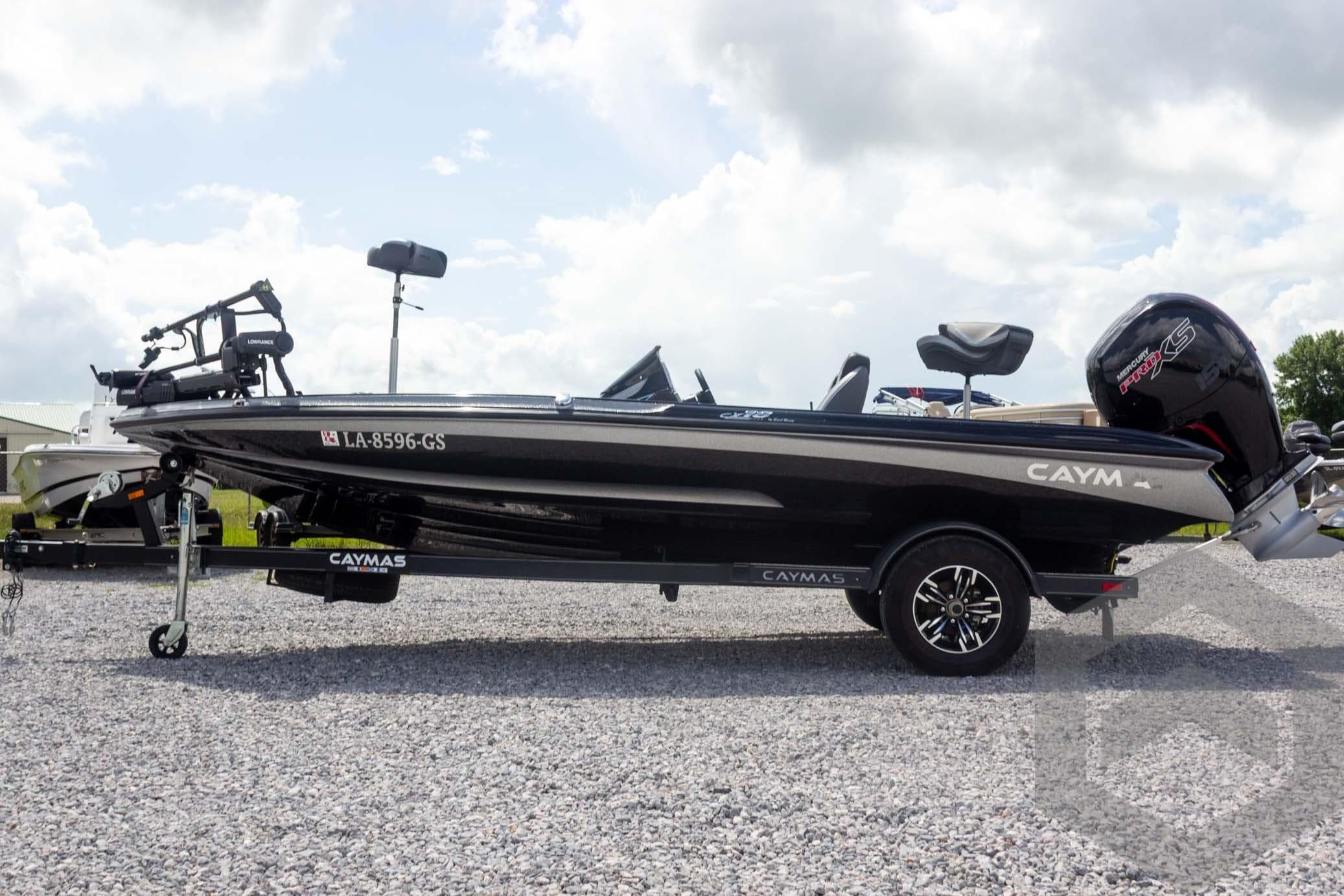 2025 Caymas CX 18 SS boat on trailer, parked on gravel under cloudy sky.