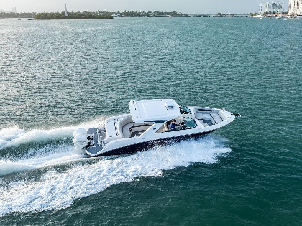 2021 Sea Ray 350 SLX OB cruising on open water, showcasing sleek design and performance.