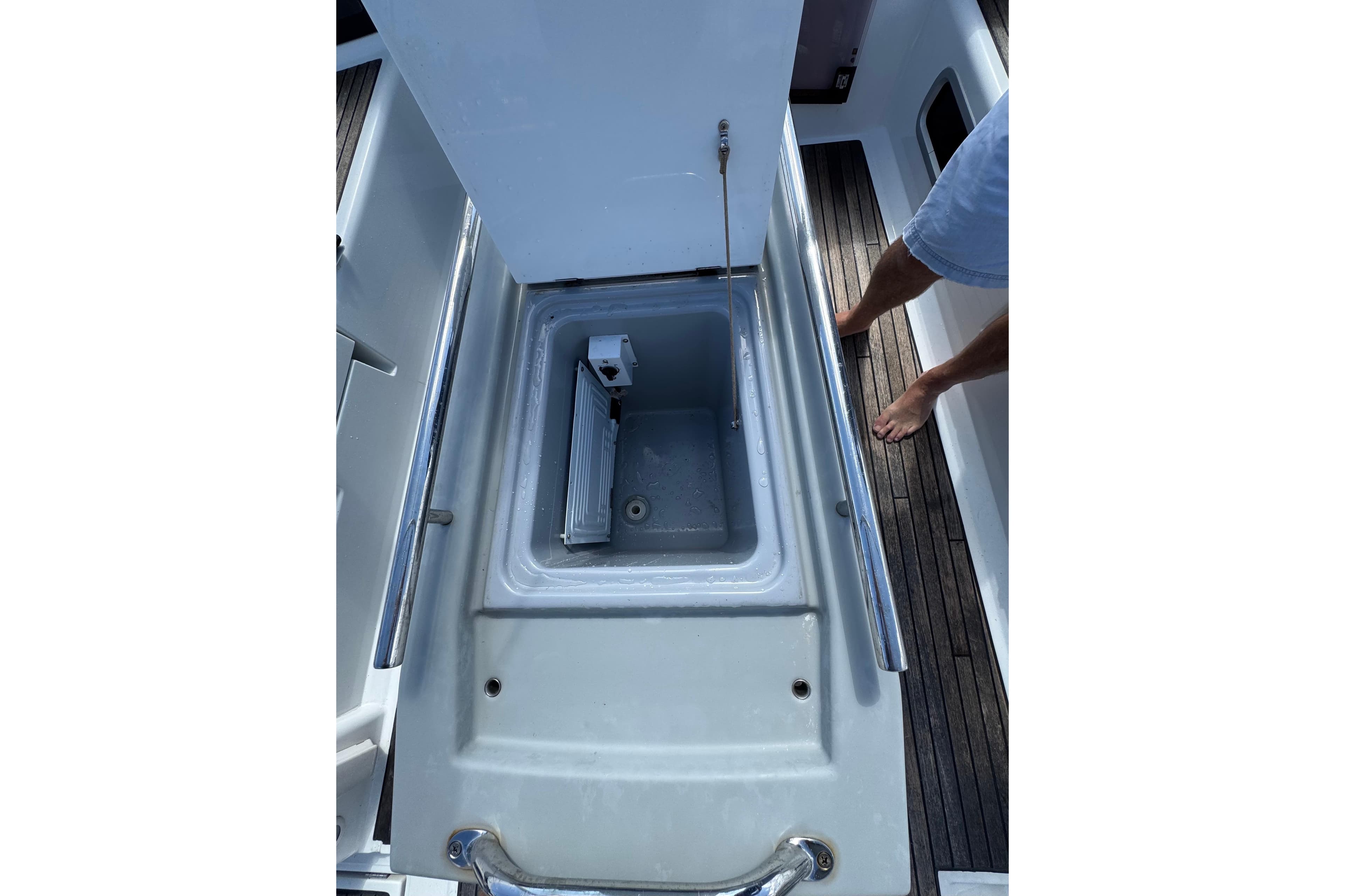 2013 Beneteau Oceanis 45 yacht cockpit storage compartment with open lid and visible interior.