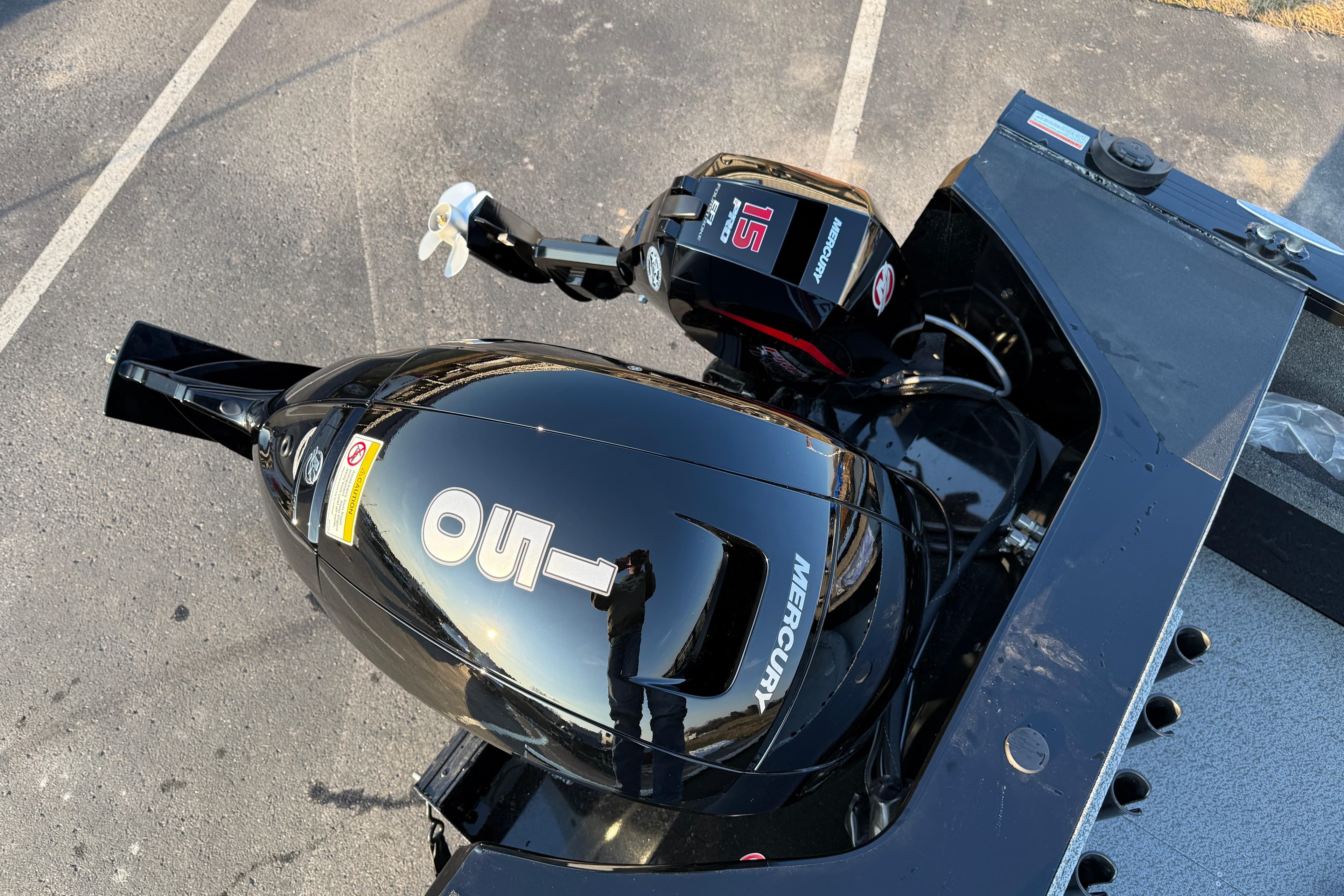 2026 Crestliner 1850 Commander Elite with Mercury outboard motor in a parking lot.
