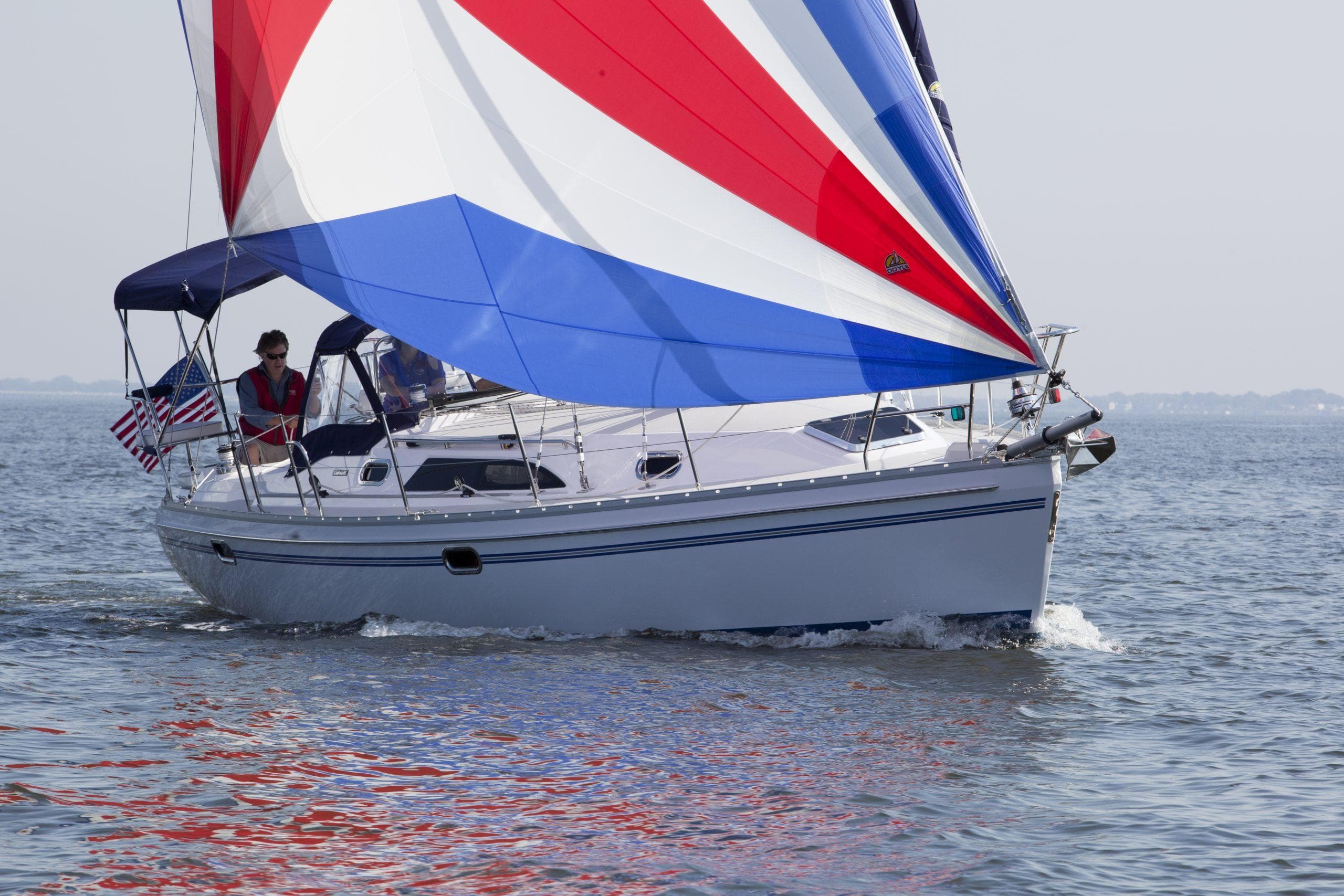 2024 Catalina 355 sailboat with colorful sails on open water.