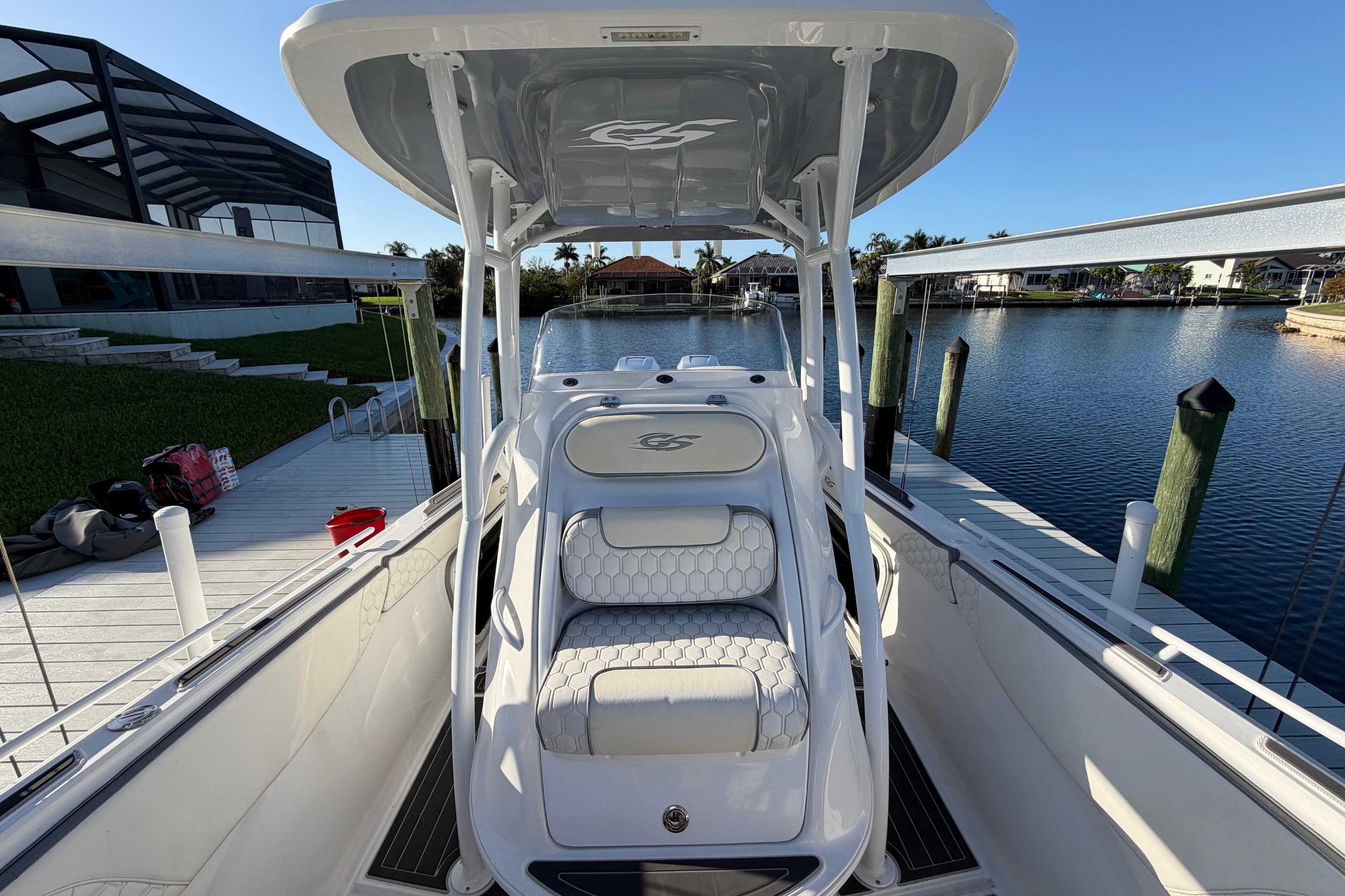 2022 Glasstream 328 Pro-XS boat docked by a serene waterfront.