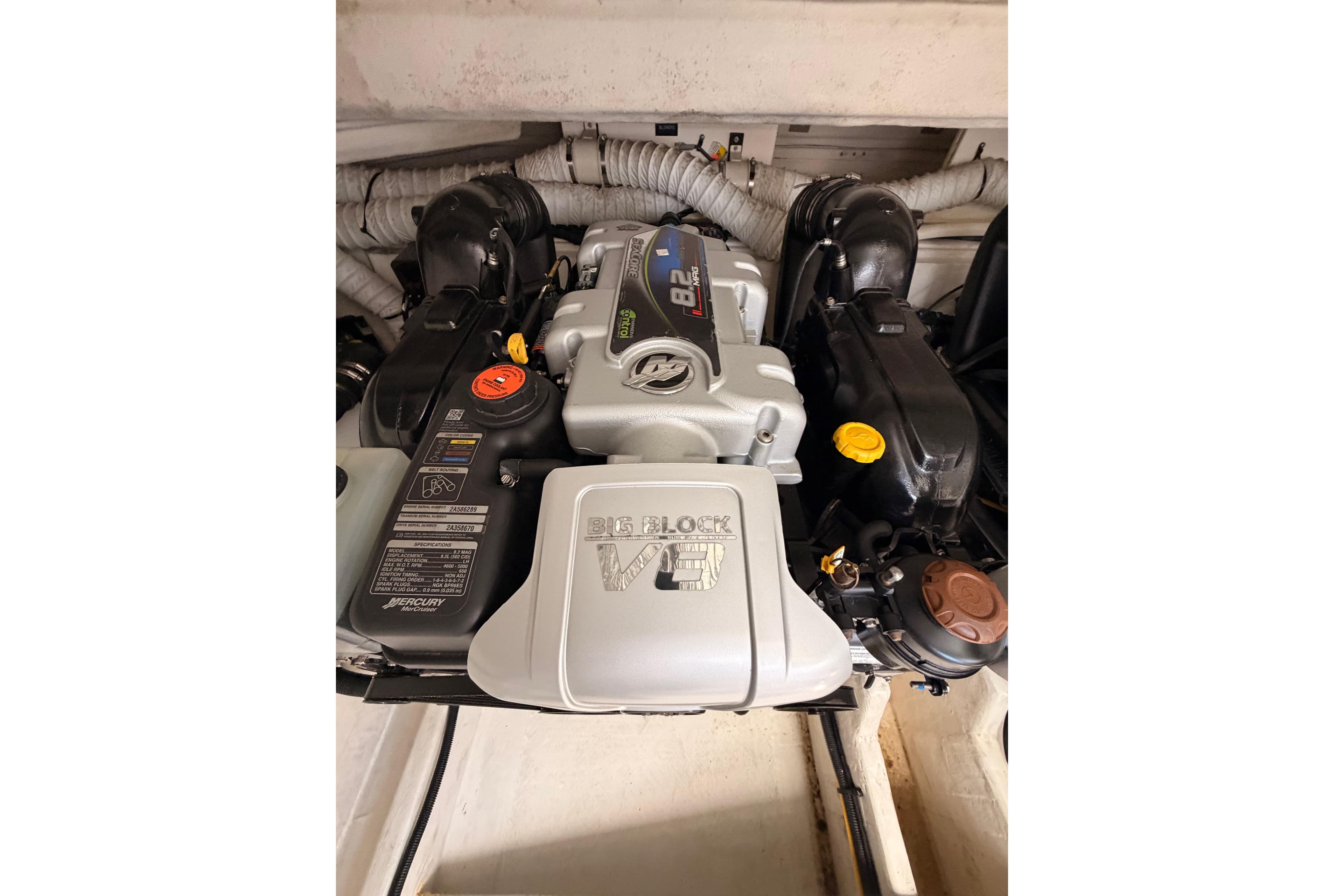 Engine compartment of 2020 Cruisers Yachts 390 Express Coupe, featuring a powerful V8 engine.