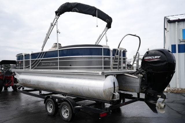 2022 South Bay 222RS LE pontoon boat on trailer with Mercury outboard motor.