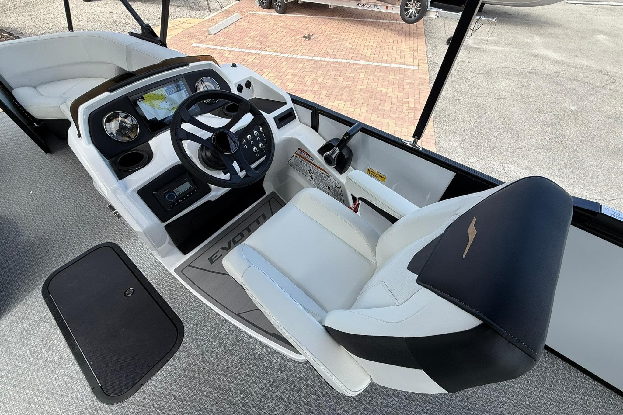 Interior of 2026 Evotti 523CS boat, featuring modern steering console and luxurious seating.