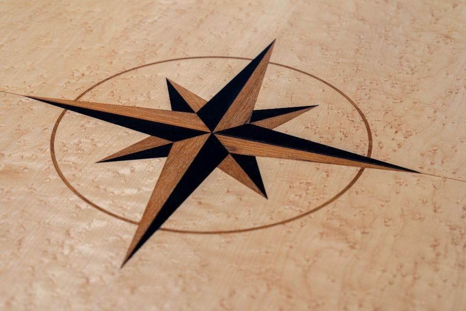 Wooden compass rose inlay on a Discovery 67 yacht, 2011 model.
