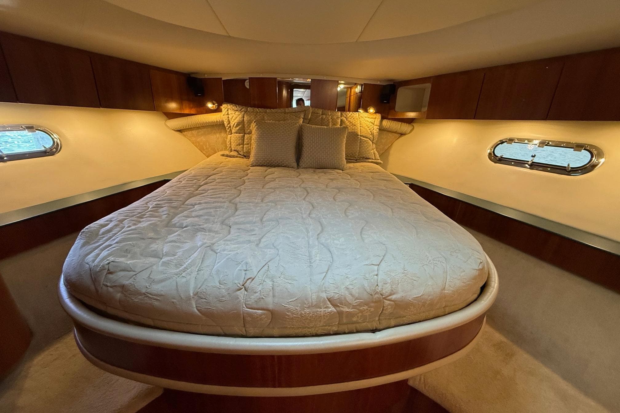 Luxurious bedroom interior of 2001 Tiara Yachts 5200 Express with elegant bedding.