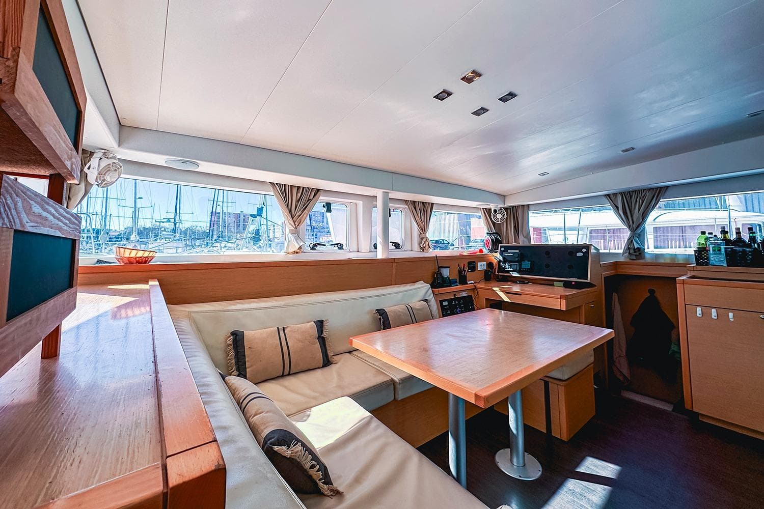 Interior of 2014 Lagoon 400 S2 catamaran with cozy seating and panoramic windows.