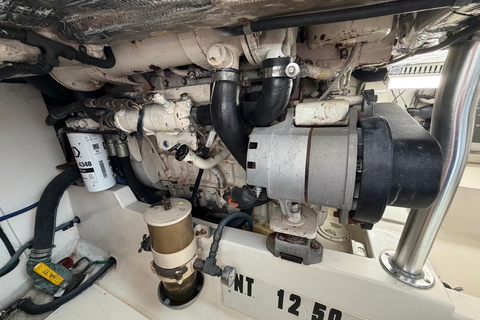 Engine compartment of a 2004 Cabo 35 Flybridge boat, showcasing mechanical components.