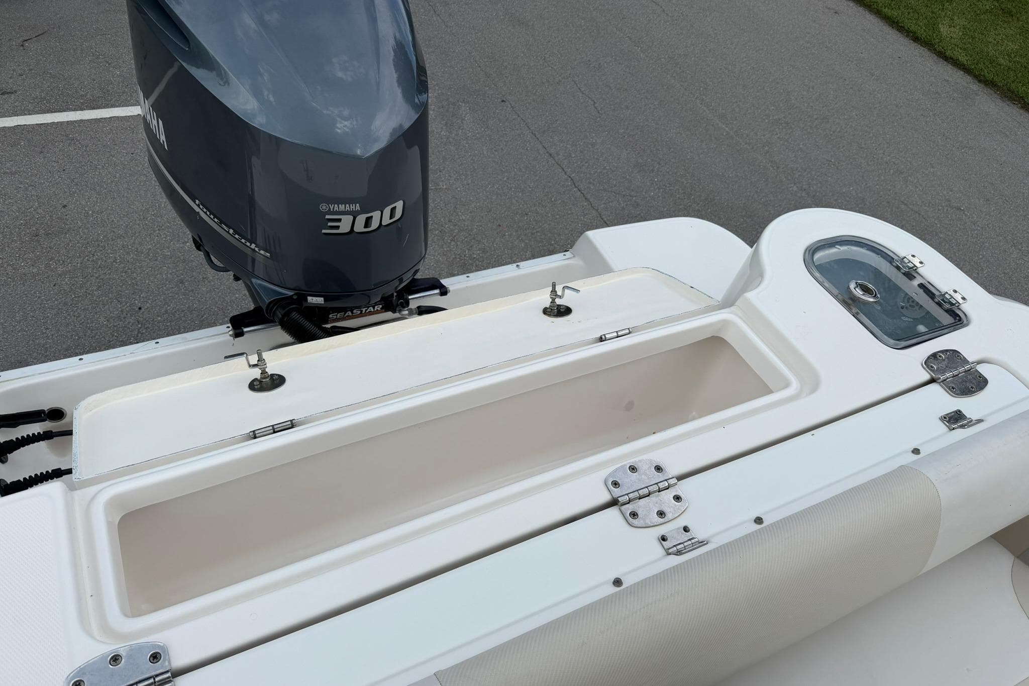 2019 Robalo R247 Dual Console boat with Yamaha 300 engine, featuring storage compartments.