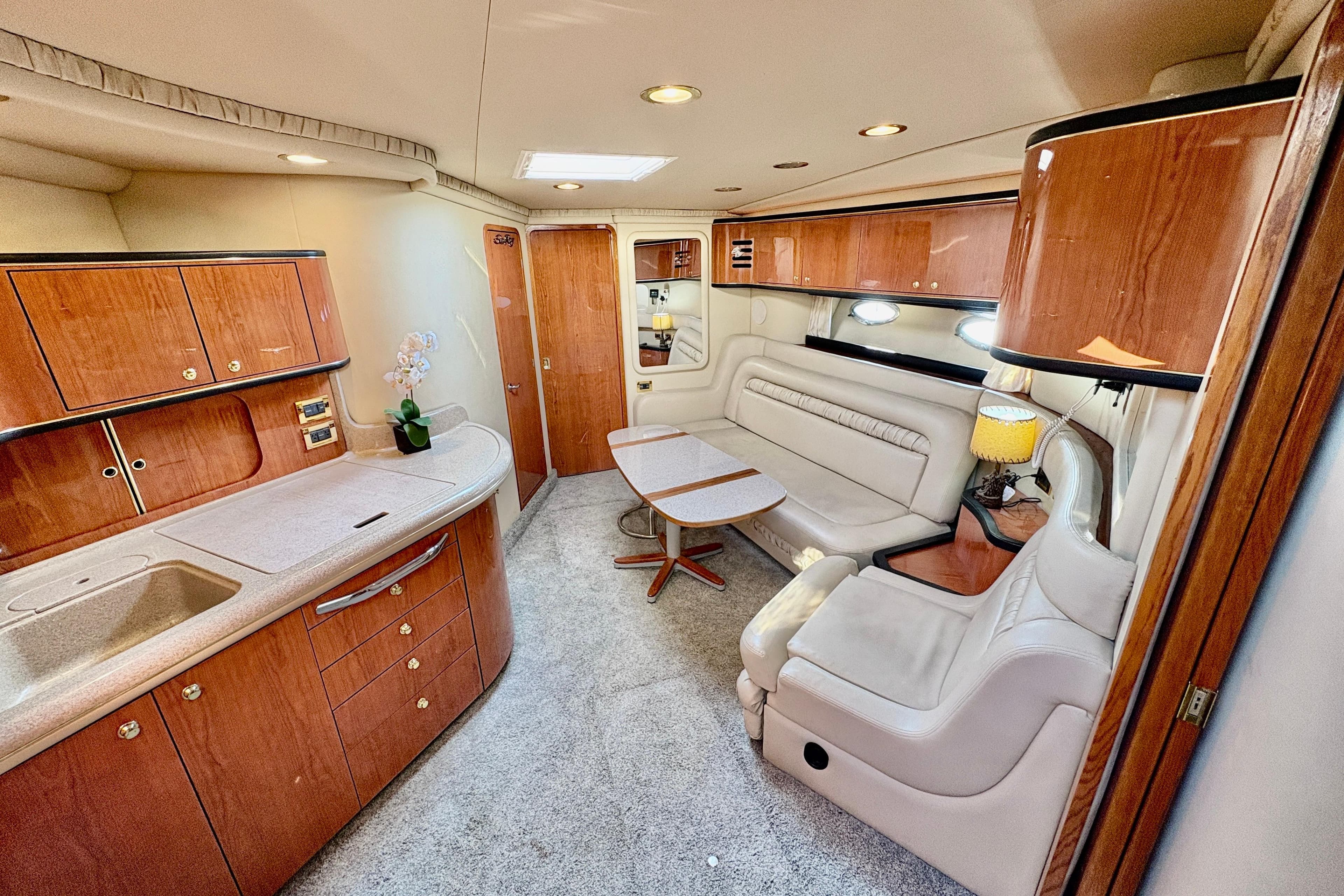 Luxurious interior of a 1999 Sea Ray 460 Sundancer yacht with elegant wood finishes.