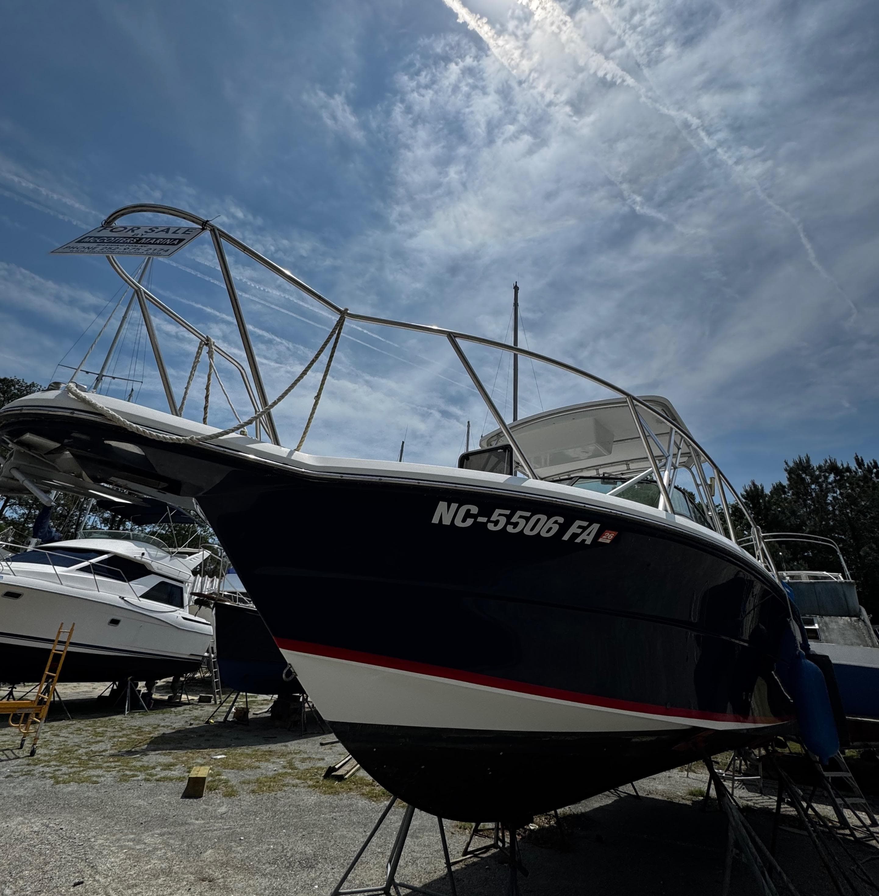 2001 Stamas 310 Express boat on dry dock under a clear sky.