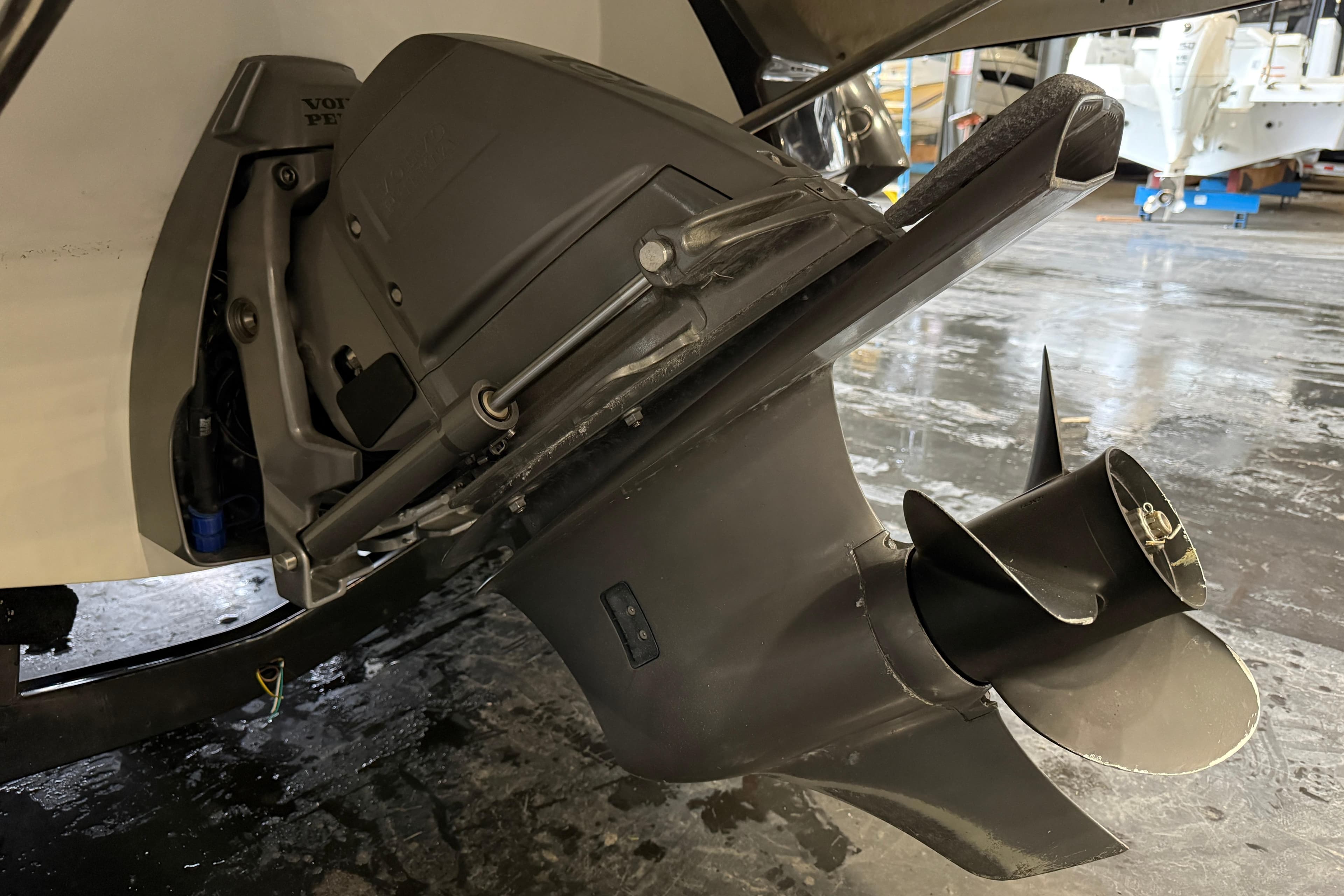 Close-up of a 2016 Monterey 224FS boat's propeller and outdrive in a garage setting.