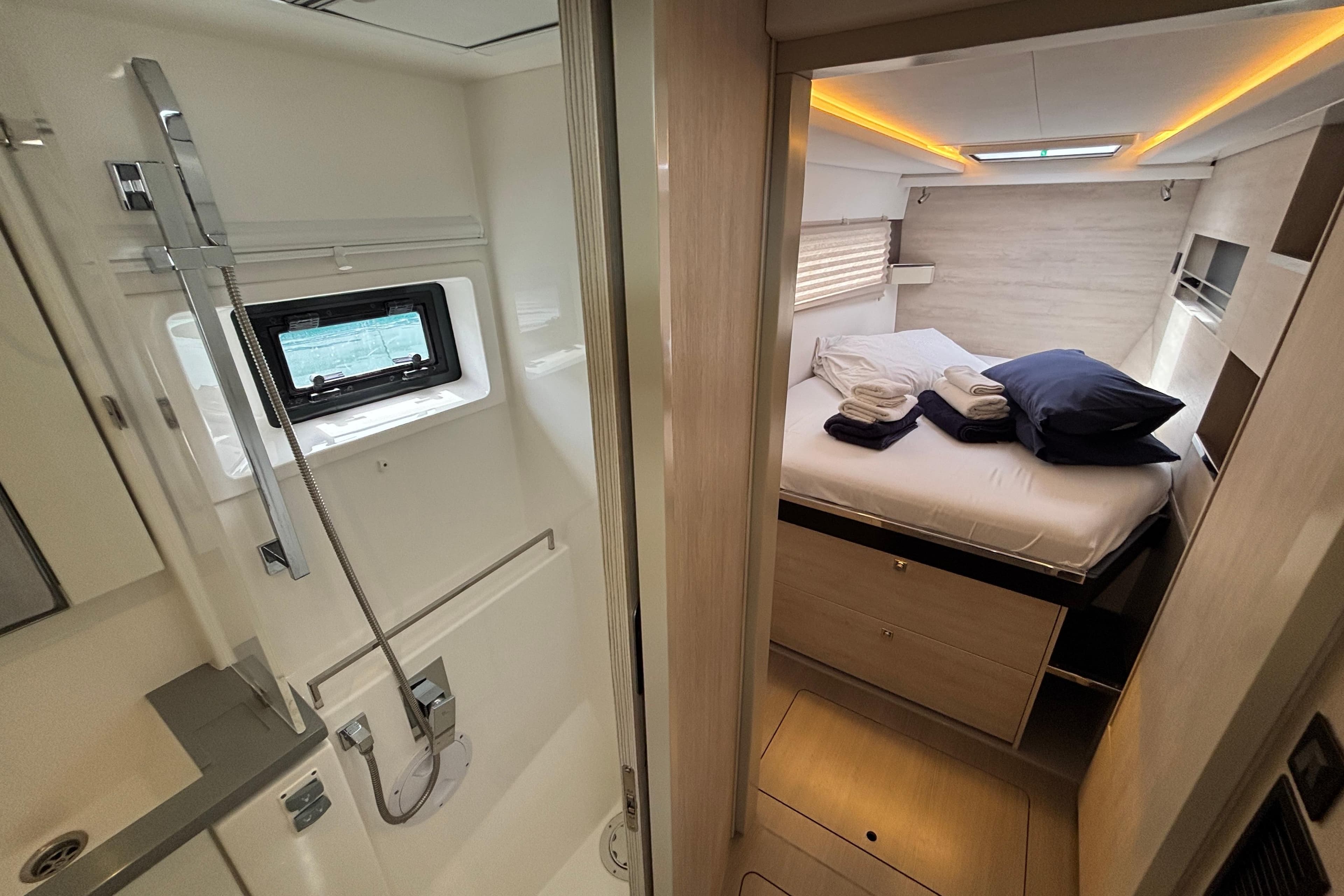 Luxurious interior of 2020 Leopard 45 yacht featuring cozy bedroom and modern bathroom.