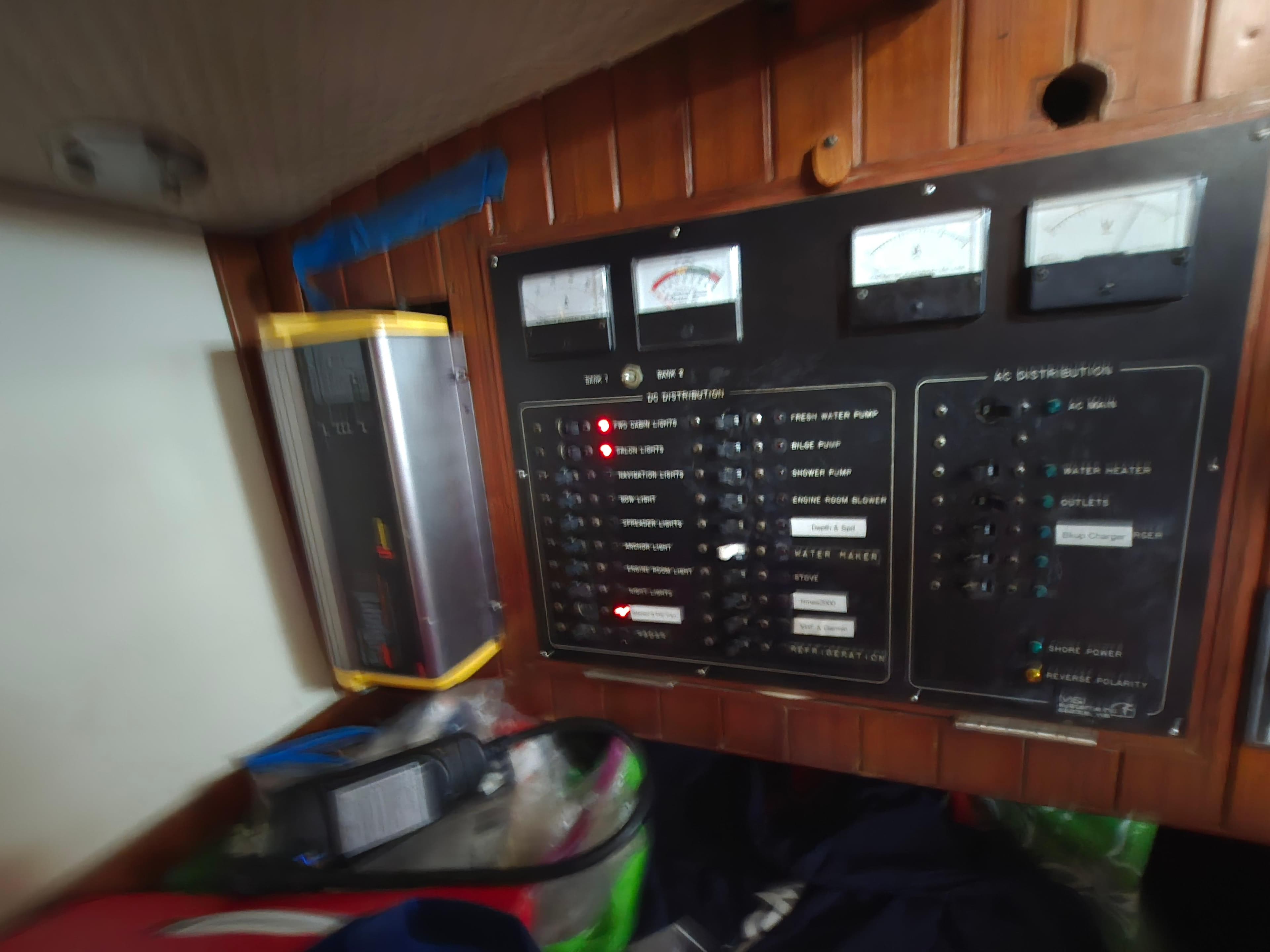 Electrical control panel on 1981 Tayana 37 Pilothouse sailboat, featuring gauges and switches.