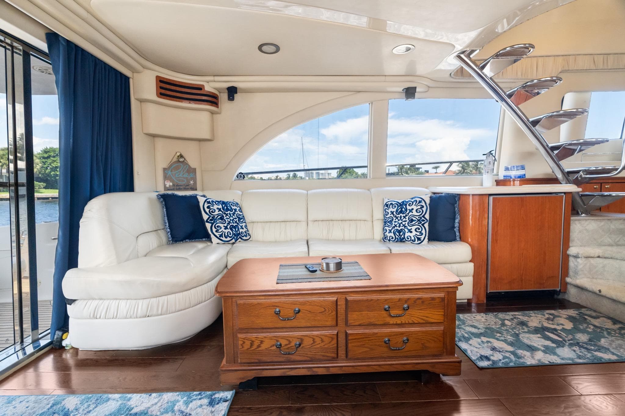 Luxurious interior of 2001 Sea Ray 540 Cockpit Motor Yacht with elegant seating and wooden accents.