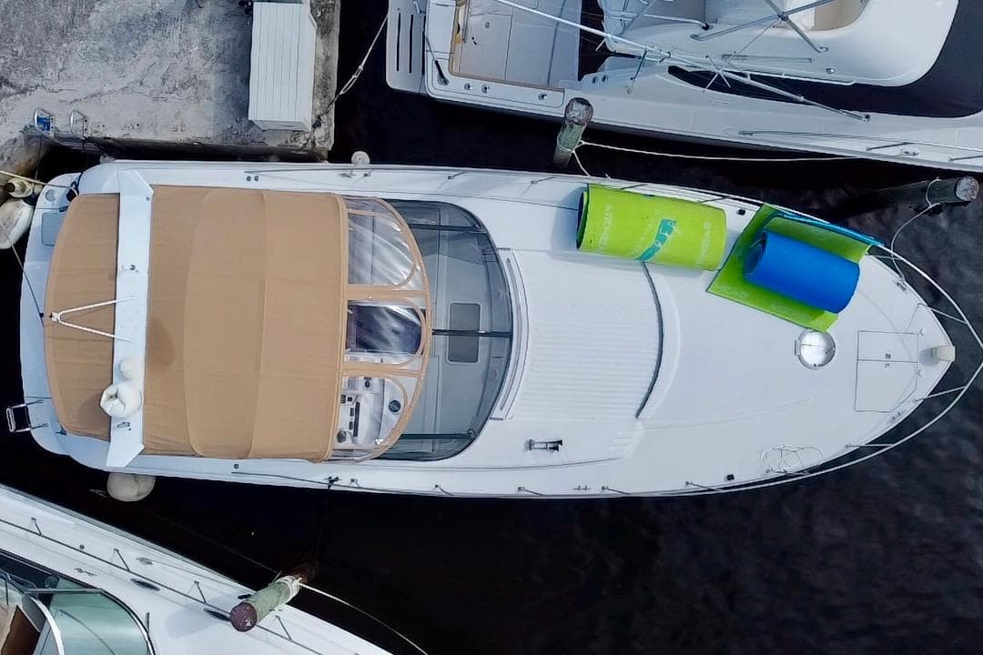 Aerial view of a 2000 Trojan 440 Express yacht docked at a marina.