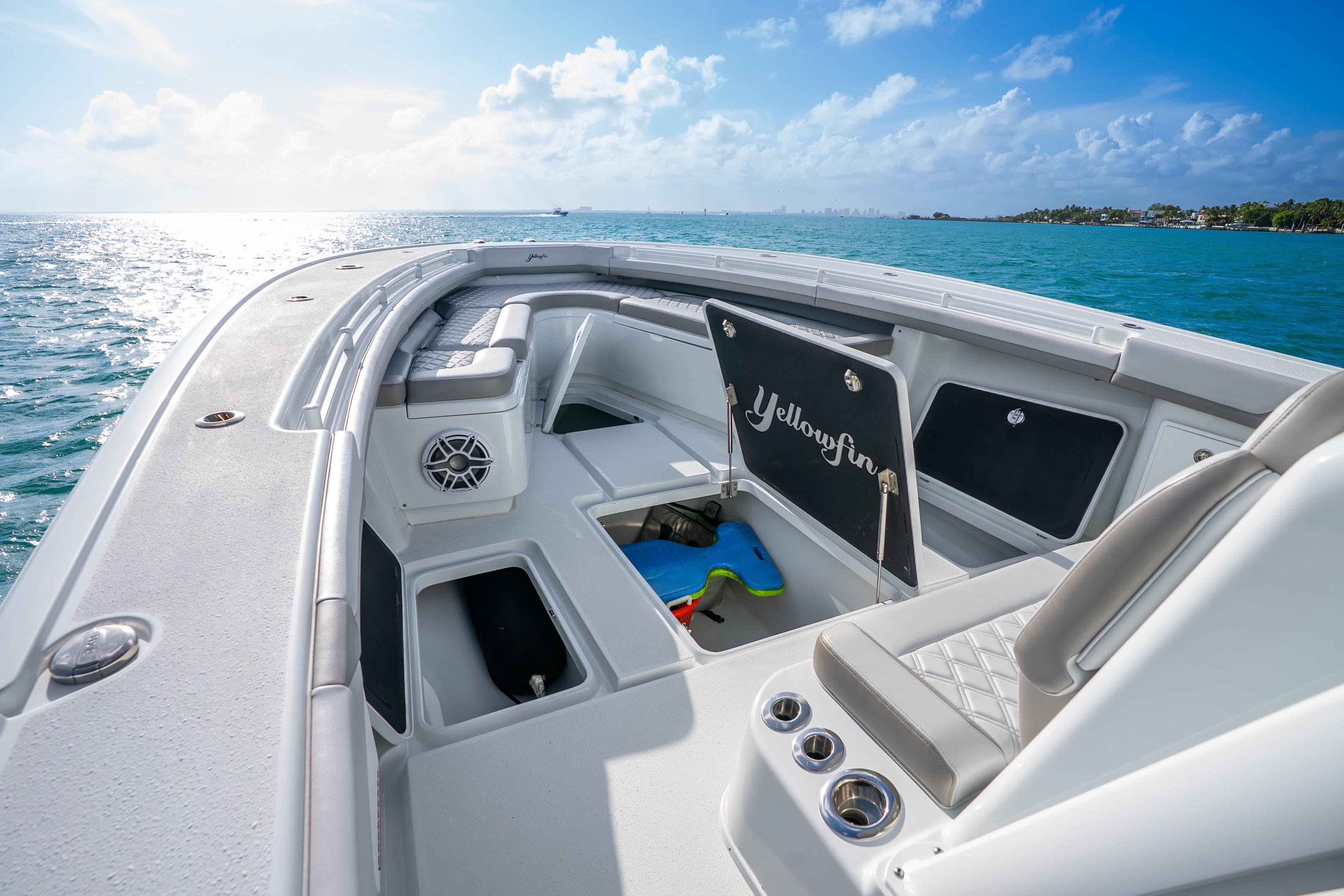 2024 Yellowfin 39 Offshore boat interior with seating, storage, and ocean view.