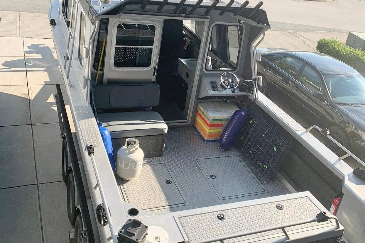 2017 Thunder Jet 28 Pilot boat interior with seating, steering wheel, and storage compartments.
