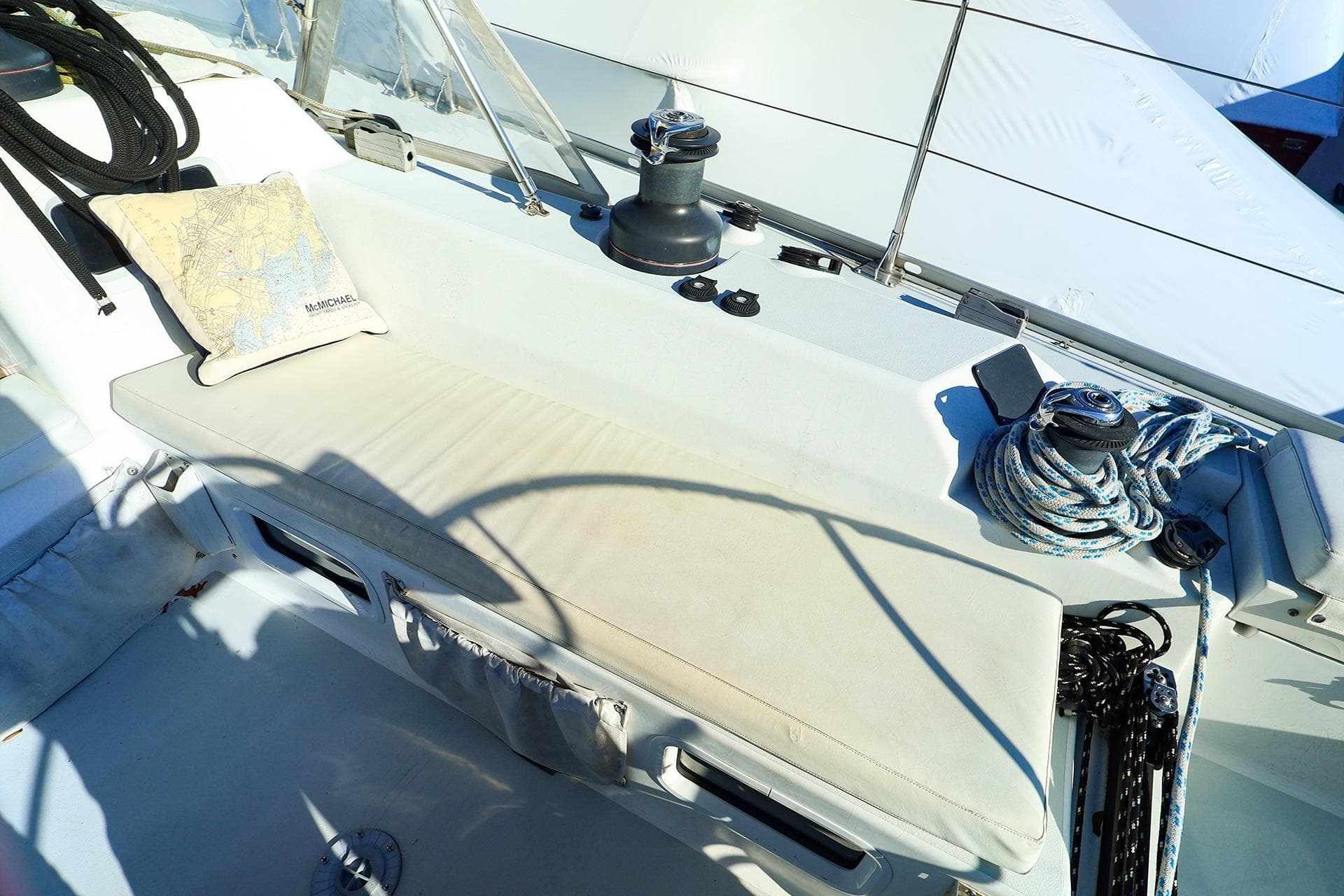 2004 J Boats J/46 sailboat cockpit with winch, ropes, and nautical map pillow.