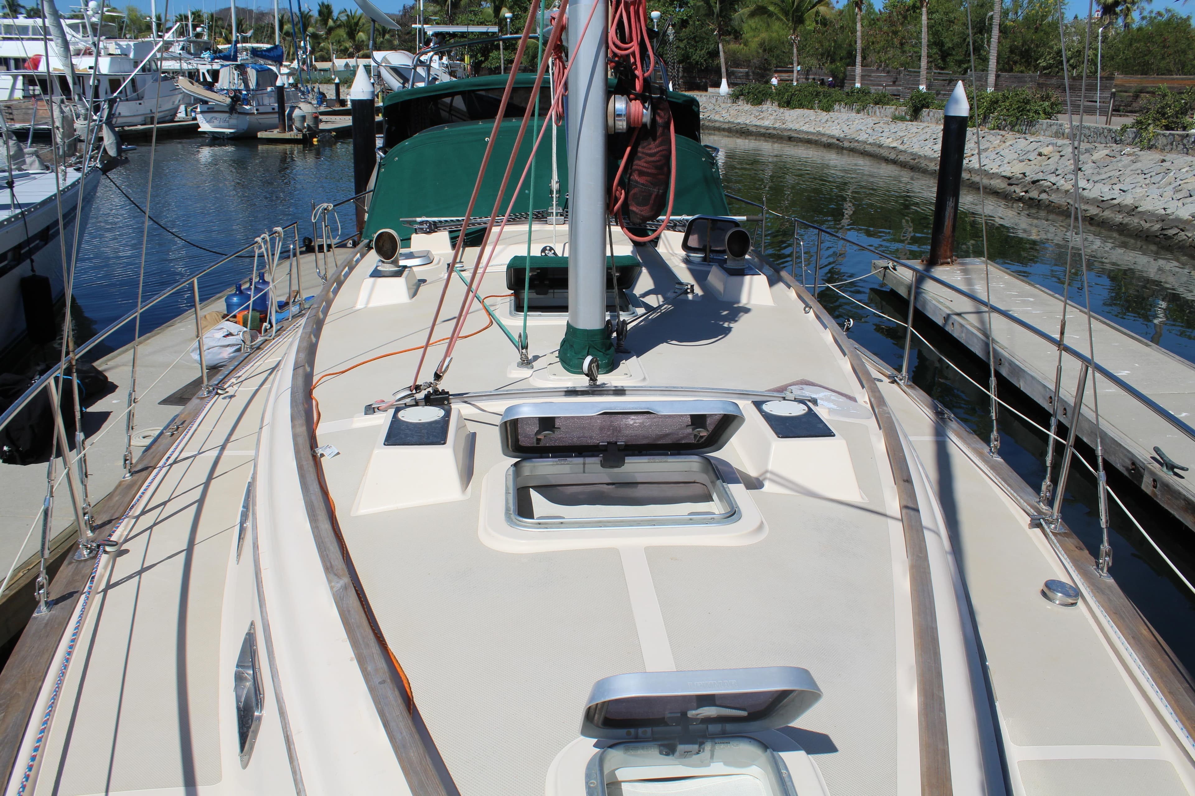 1994 Island Packet 40 sailboat deck view in marina, showcasing rigging and hatches.