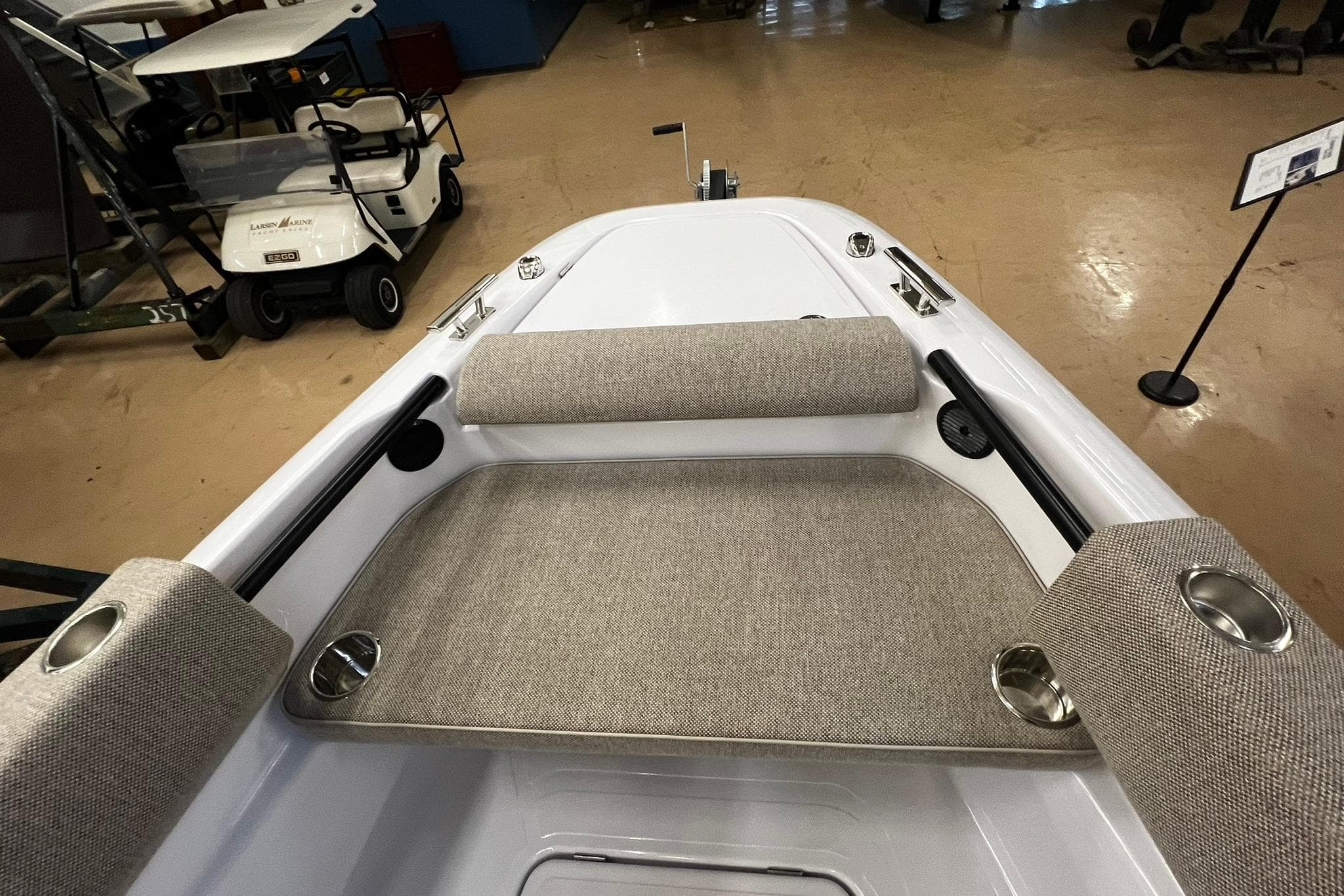 2025 Axopar 22 Spyder boat interior with cushioned seating and cup holders.