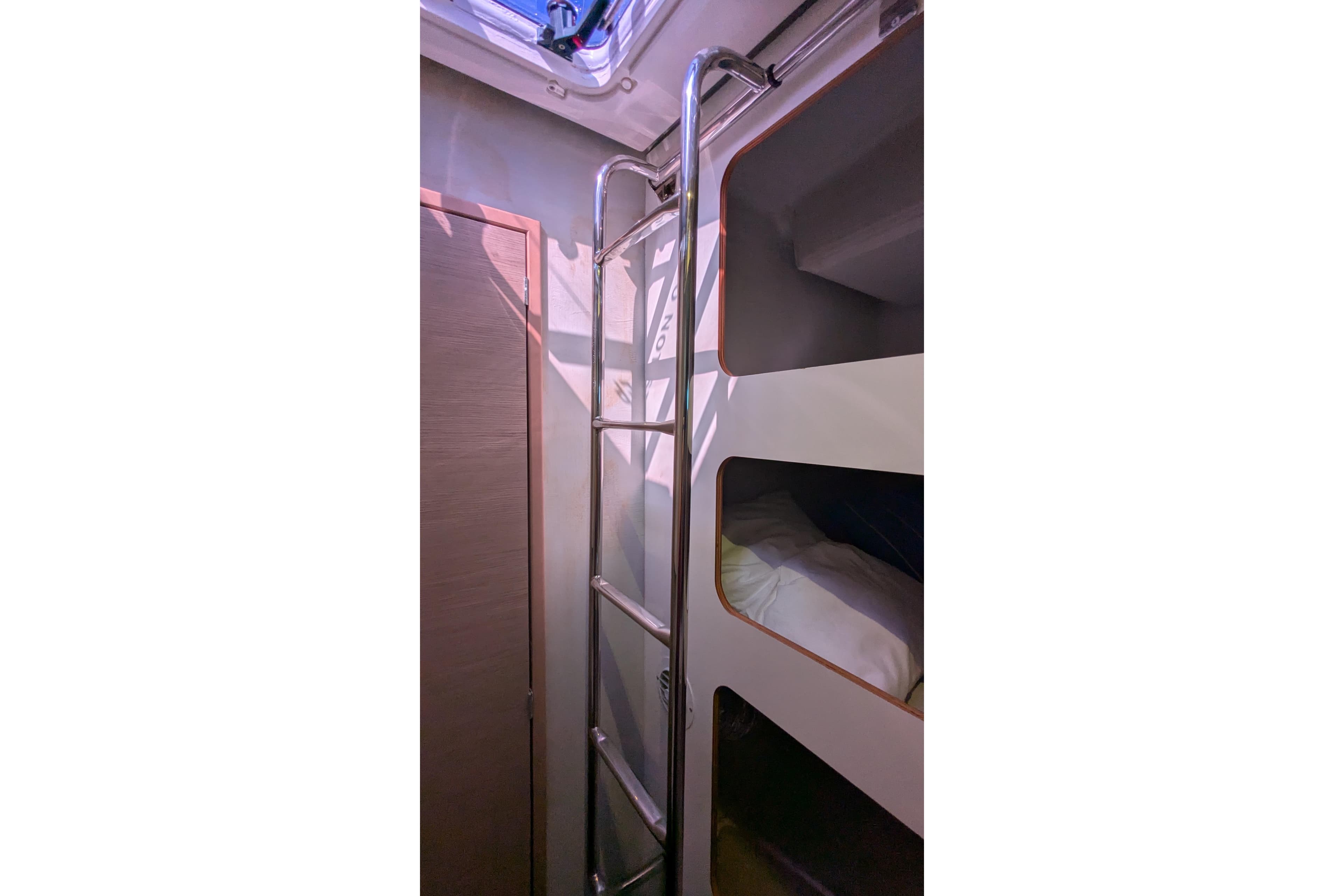 Interior of 2020 Fountaine Pajot Saona 47 yacht with bunk beds and ladder.