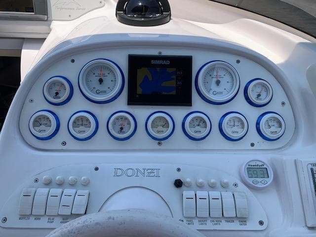 Dashboard of a 2000 Donzi 38 ZX boat with gauges and controls.