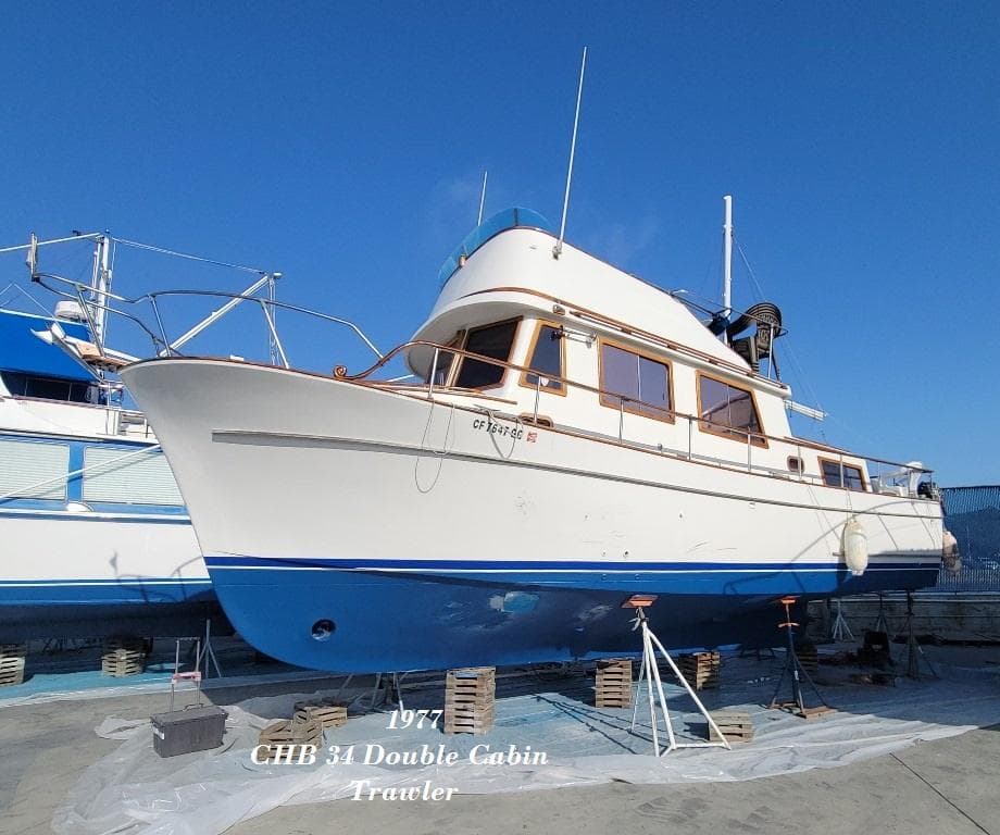 1977 CHB 34 Double Cabin Trawler on dry dock, blue and white hull.