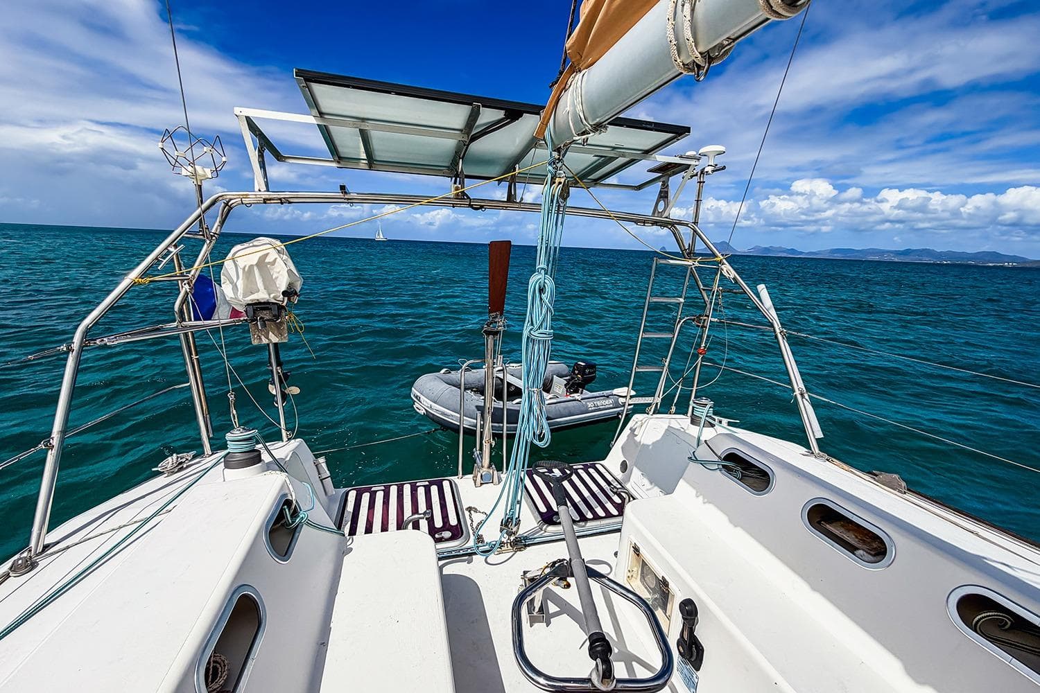 Sailing on RM Yachts 1050, 2006 model, with ocean view and clear skies.