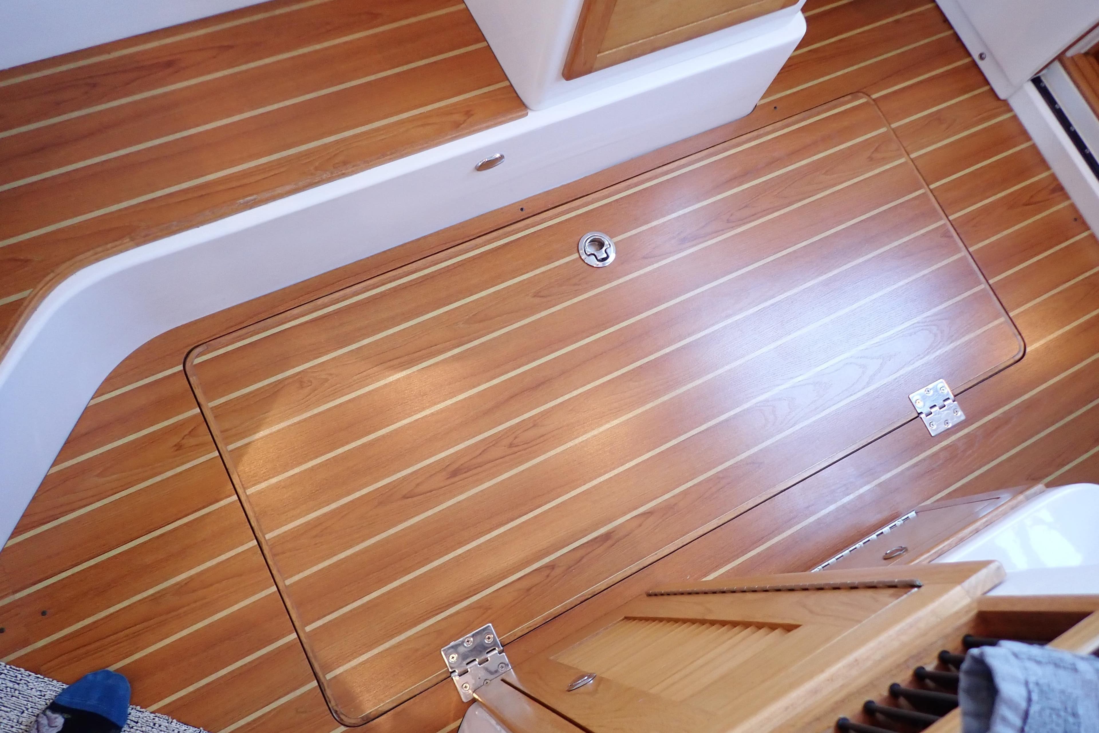 Teak flooring on 2023 True North 34 Outboard Express boat interior.
