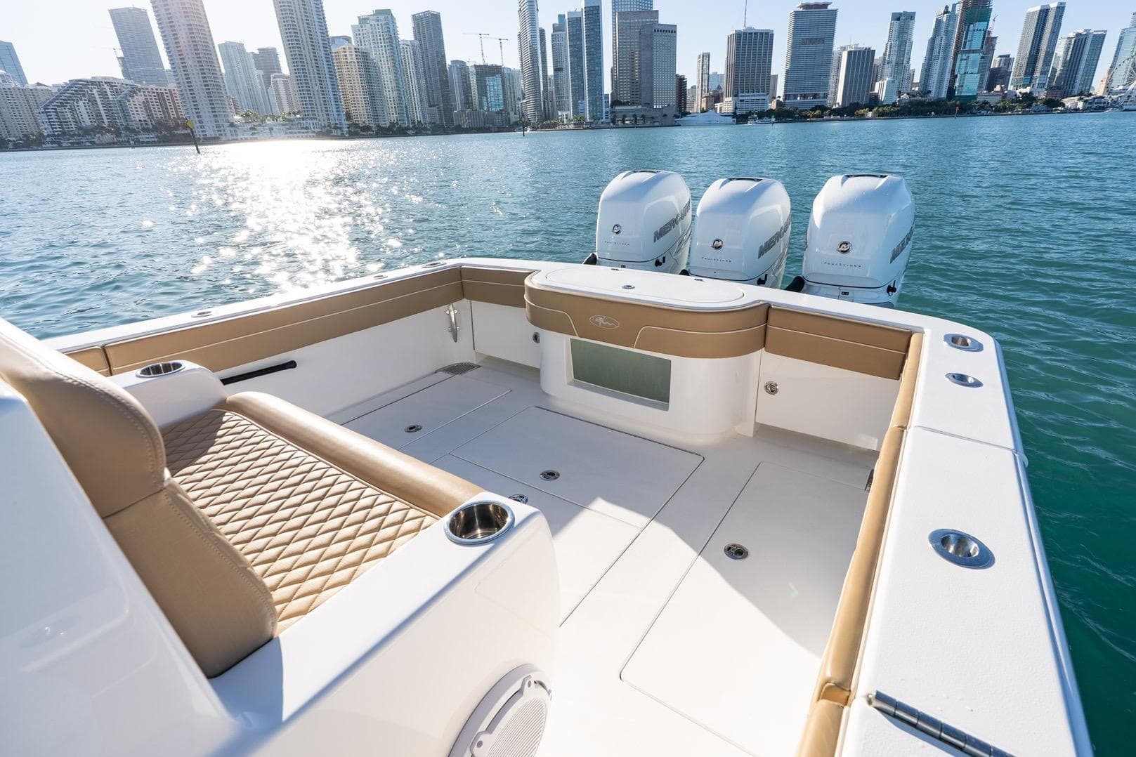 2022 Valhalla Boatworks V-37 with triple engines, city skyline in background.