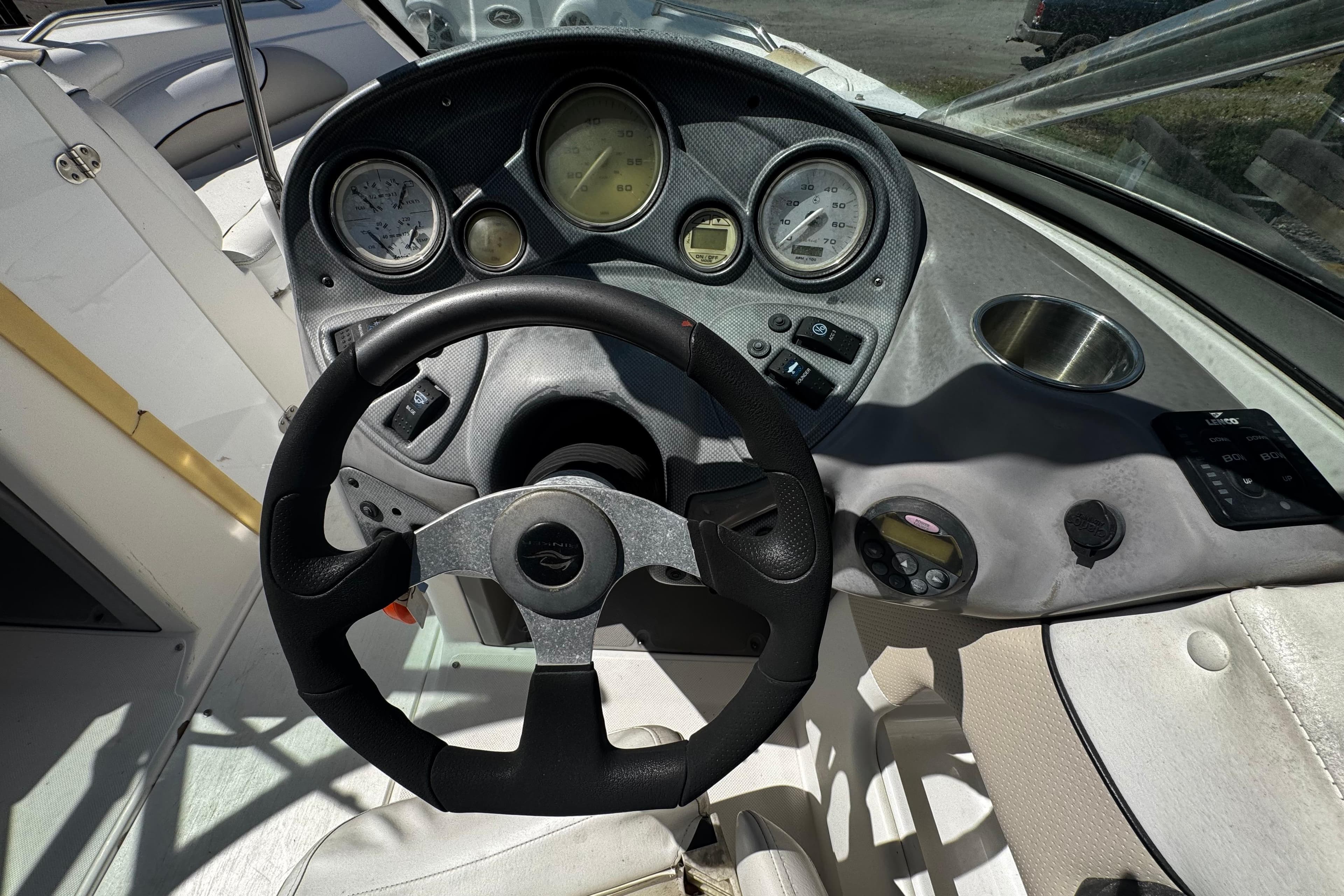 2008 Rinker 226 Captiva Bowrider dashboard with steering wheel and gauges.