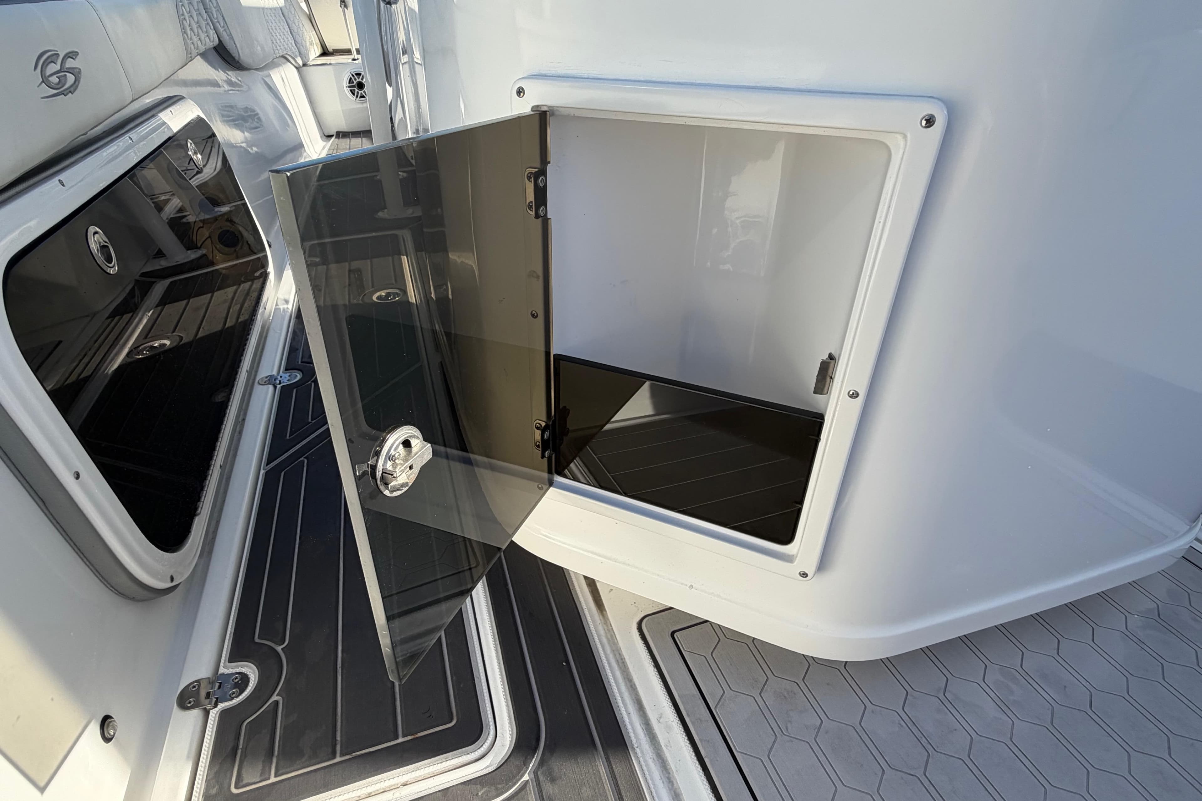 2022 Glasstream 328 Pro-XS boat storage compartment with open door, showcasing sleek interior design.