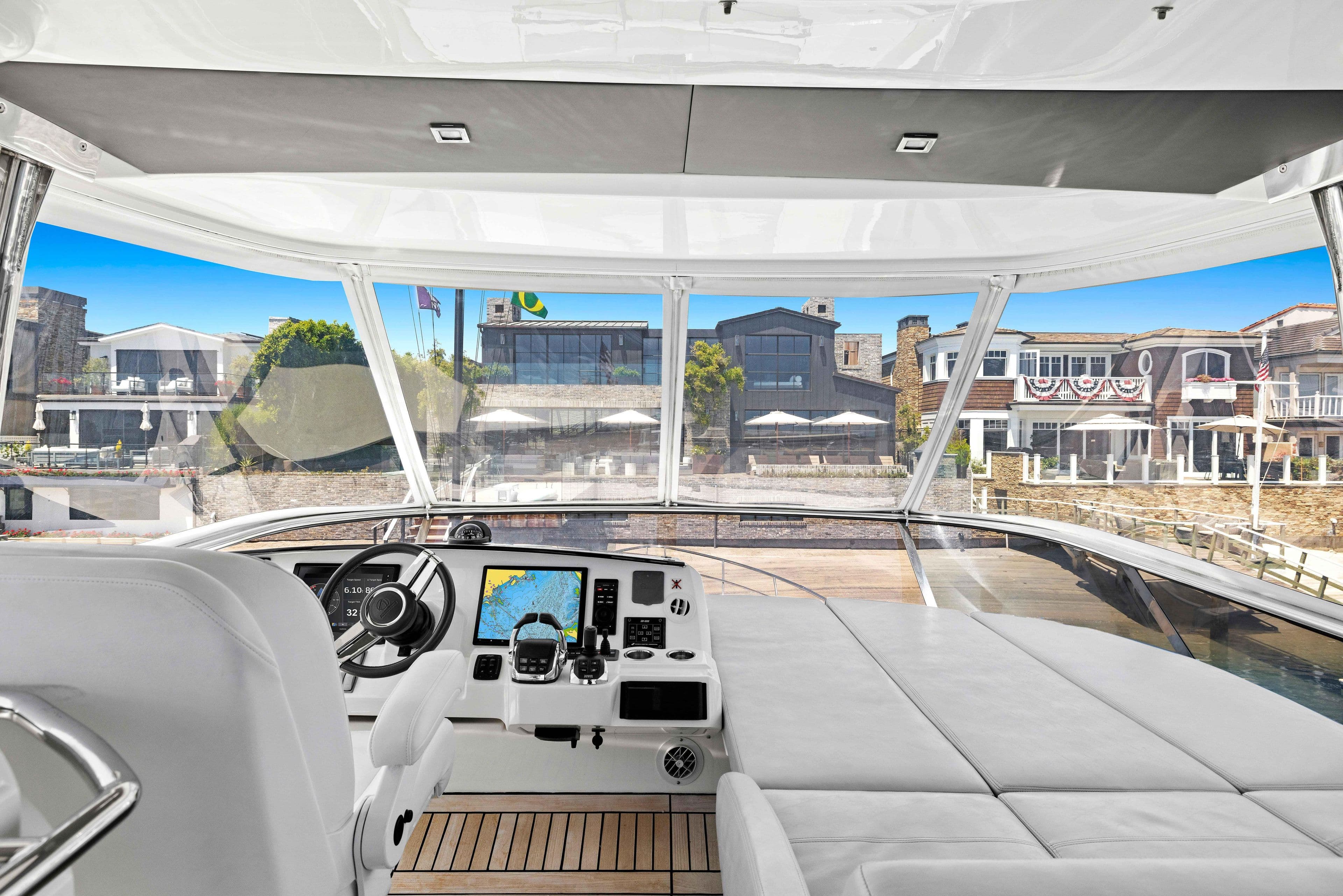 Luxurious 2015 Absolute 64 FLY yacht interior with modern helm and waterfront view.