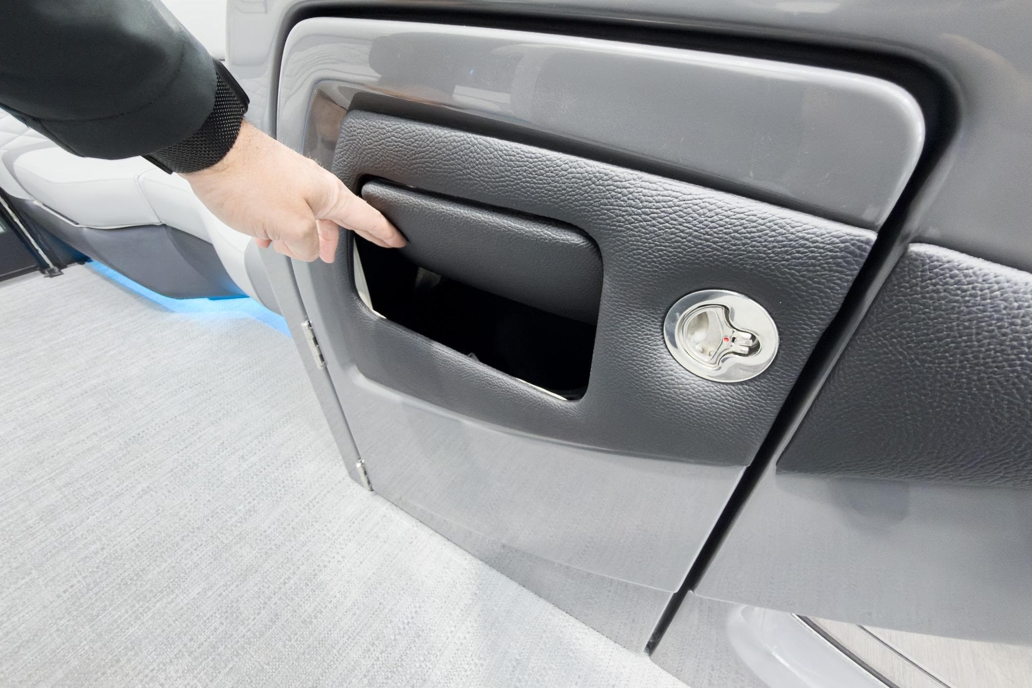 Hand opening storage compartment on 2026 Godfrey Monaco 25' Tritoon boat.