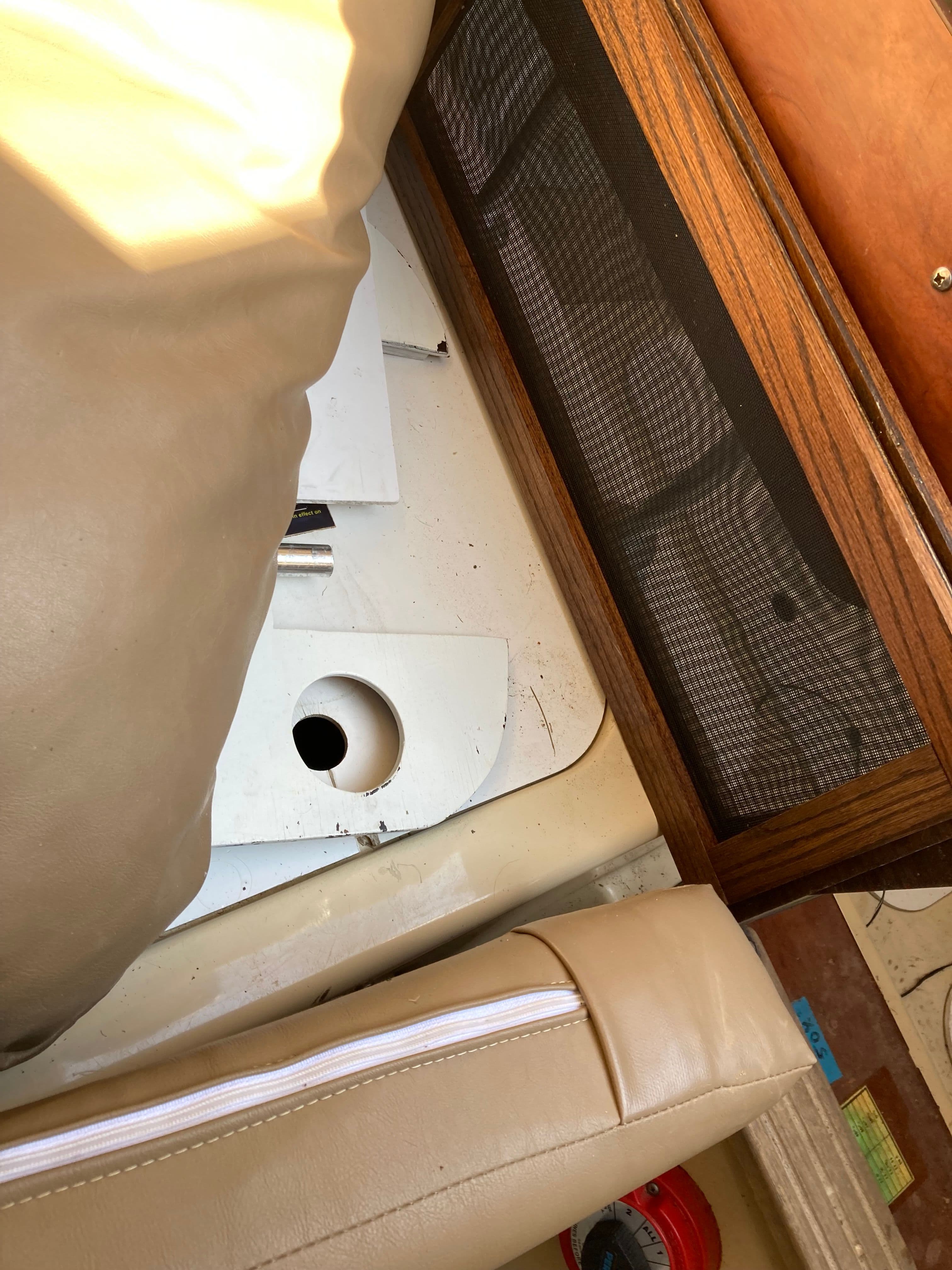 Interior of a 2007 MacGregor 26 boat with upholstery and wood paneling.