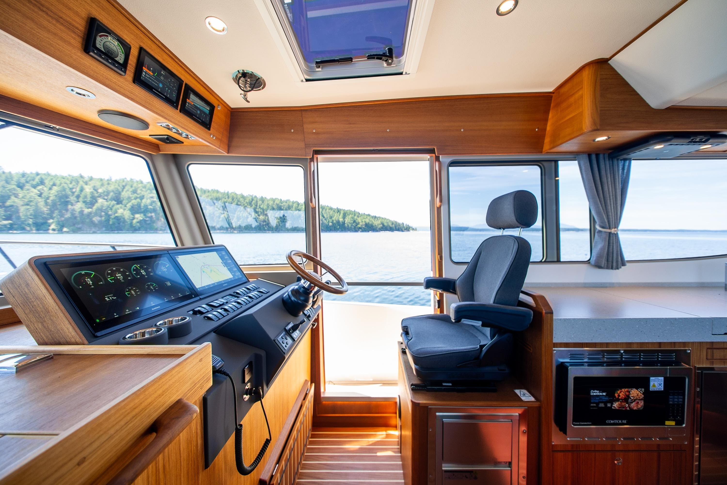 Interior of 2026 Targa 41 boat with modern helm and scenic water view.