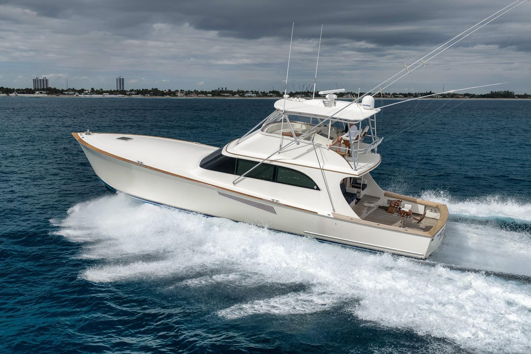 1999 Hines-Farley SPORTFISHERMAN yacht cruising on open water under cloudy skies.