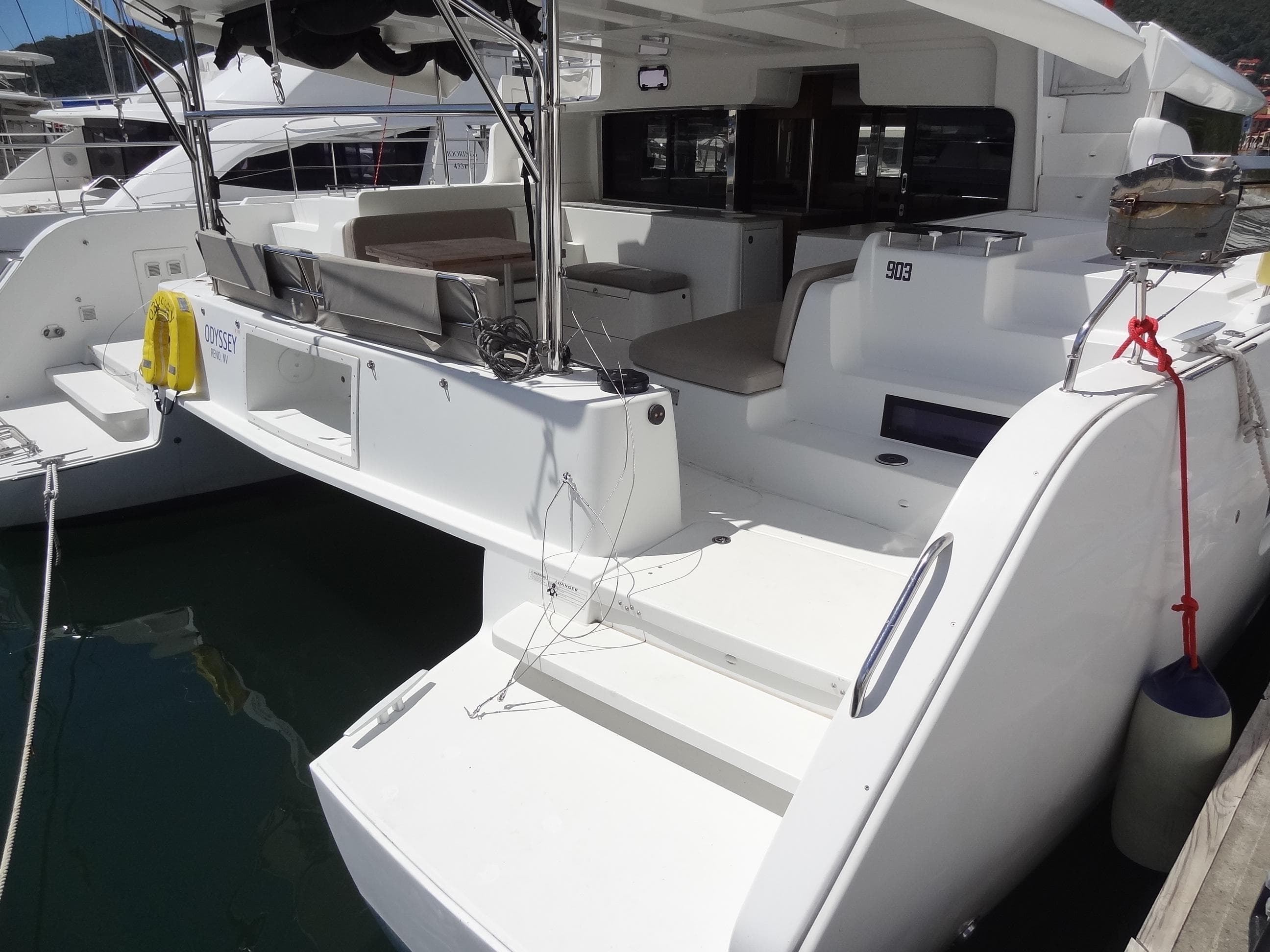 2020 Lagoon 46 catamaran with spacious deck and seating area, docked at marina.