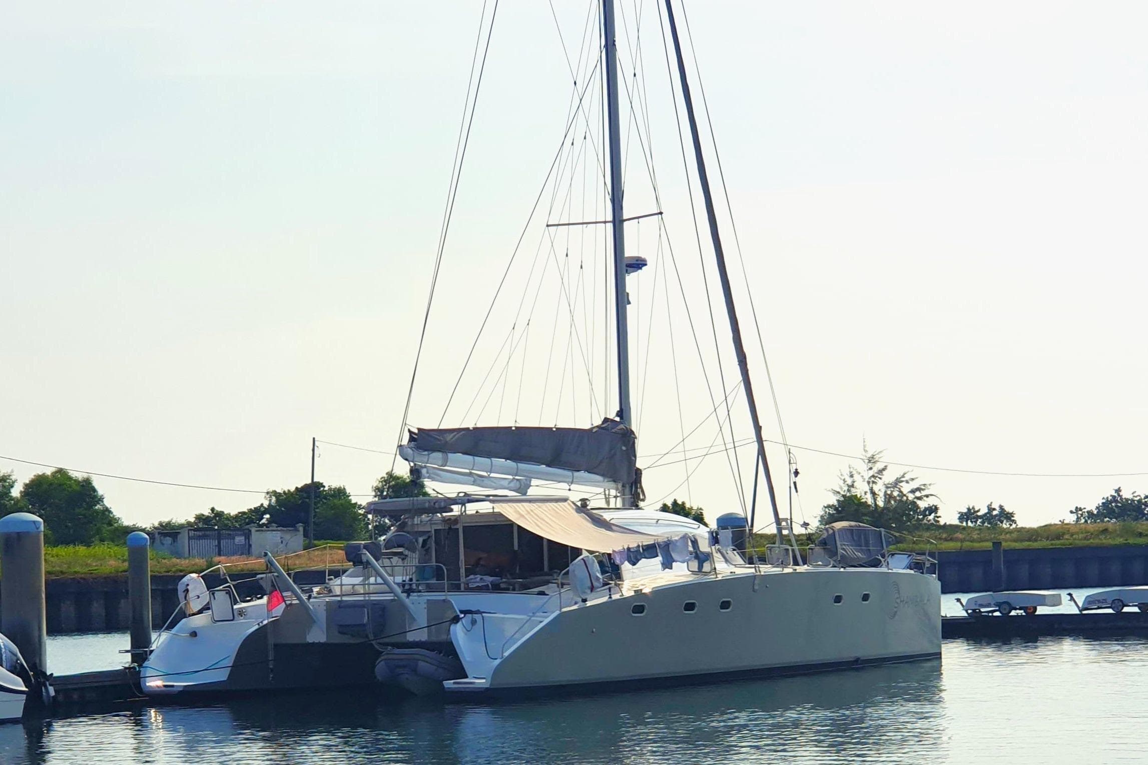 Sailing catamaran Multicap Caraibes PUNCH 1500 LC 2003 docked at marina.