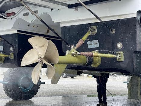 Close-up of 2010 Axcell Yachts 650 Power Catamaran propeller and undercarriage during maintenance.