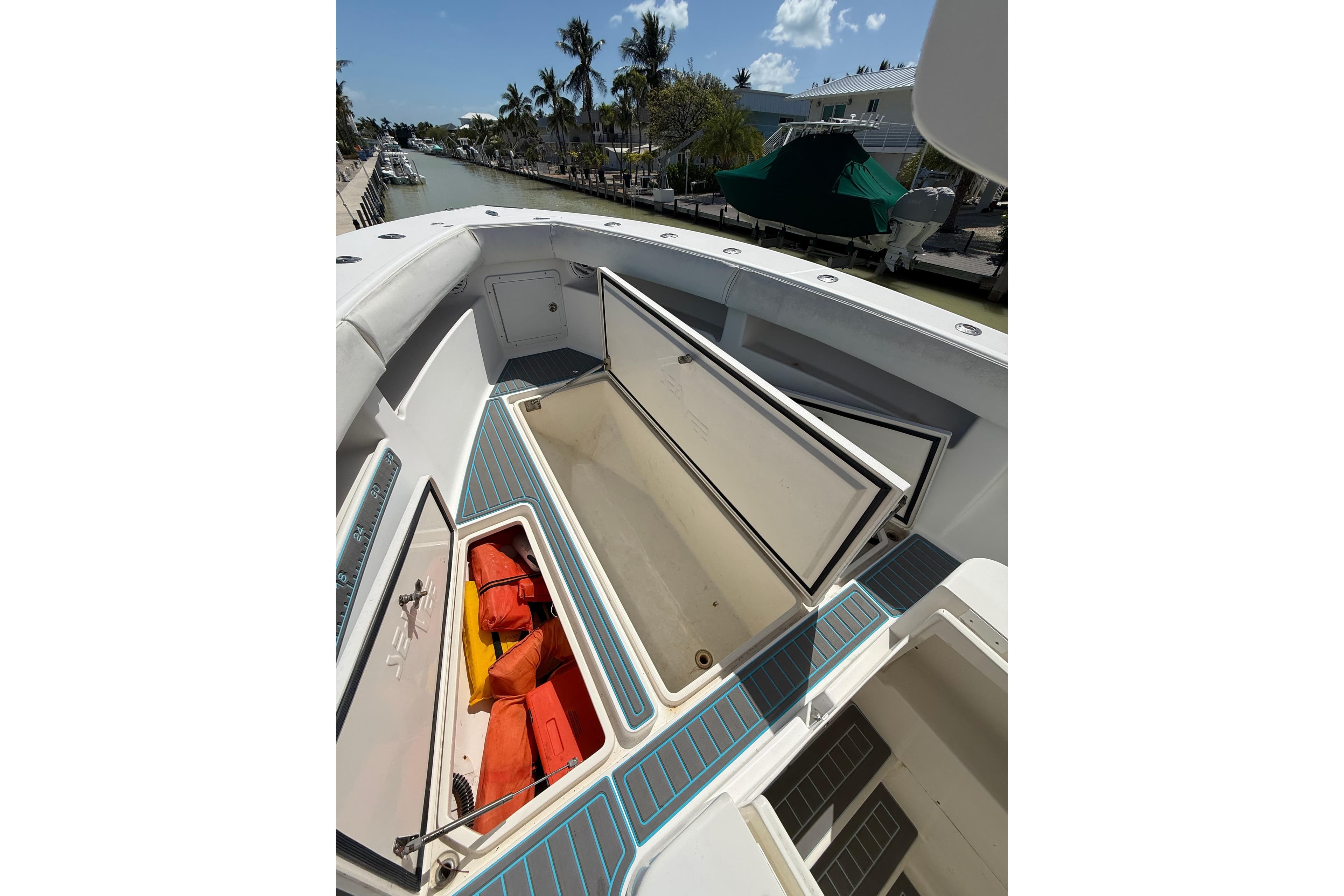 2006 SeaVee 290B boat deck with open storage compartments and life jackets.