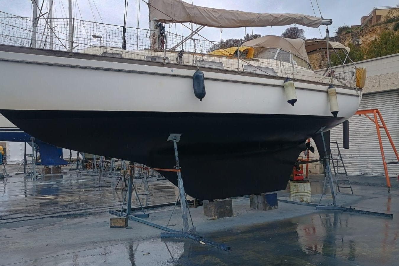 1978 Najad 34 sailboat on dry dock, showcasing hull and deck details.
